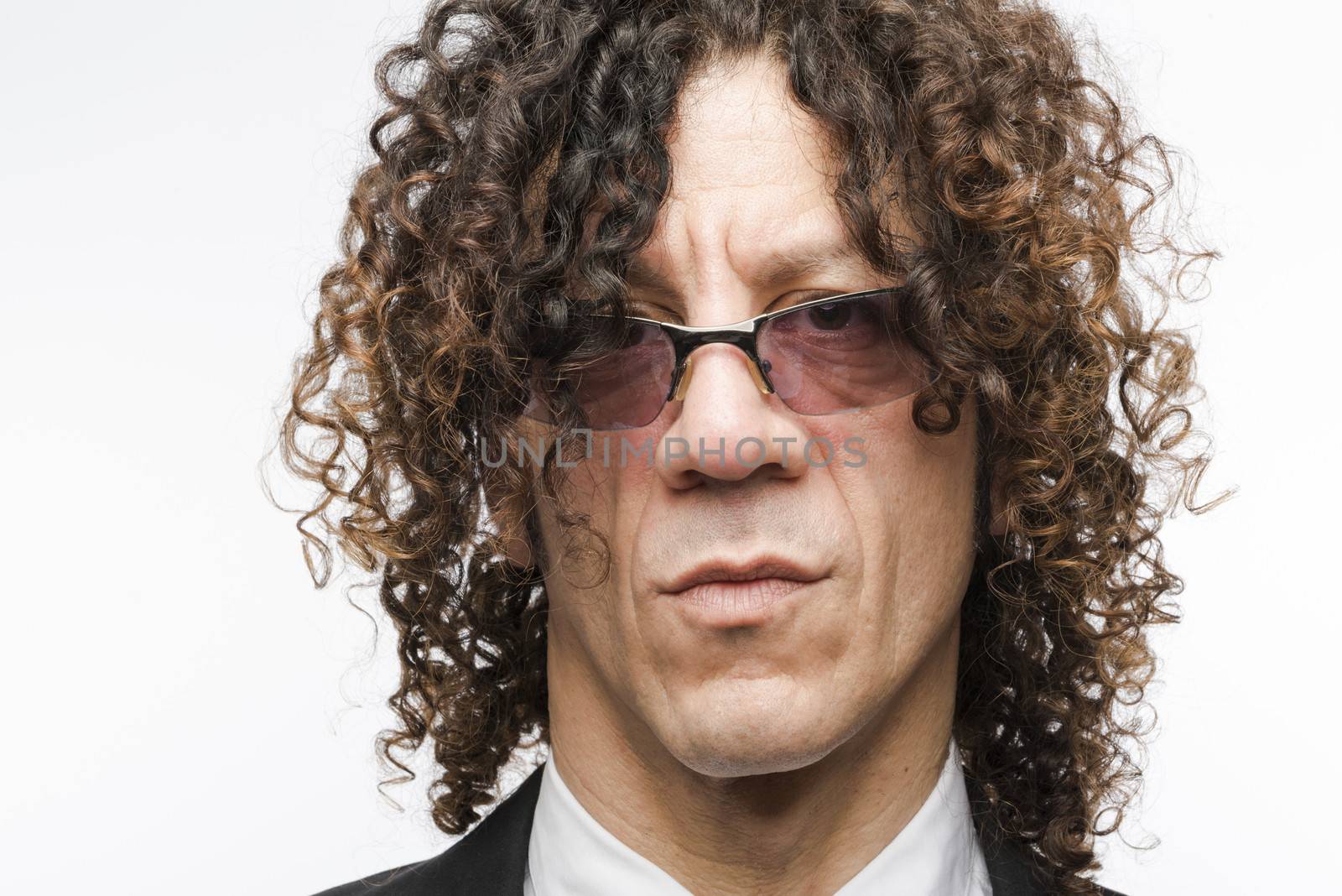 Headshot of serious mediterranean man wearing designer glasses