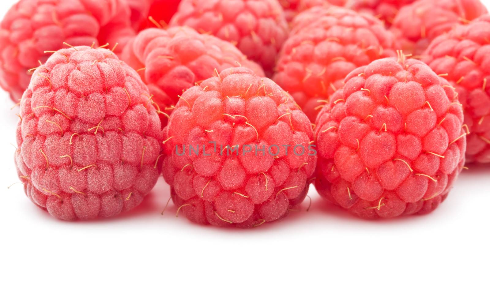 Ripe red raspberries isolated on white background