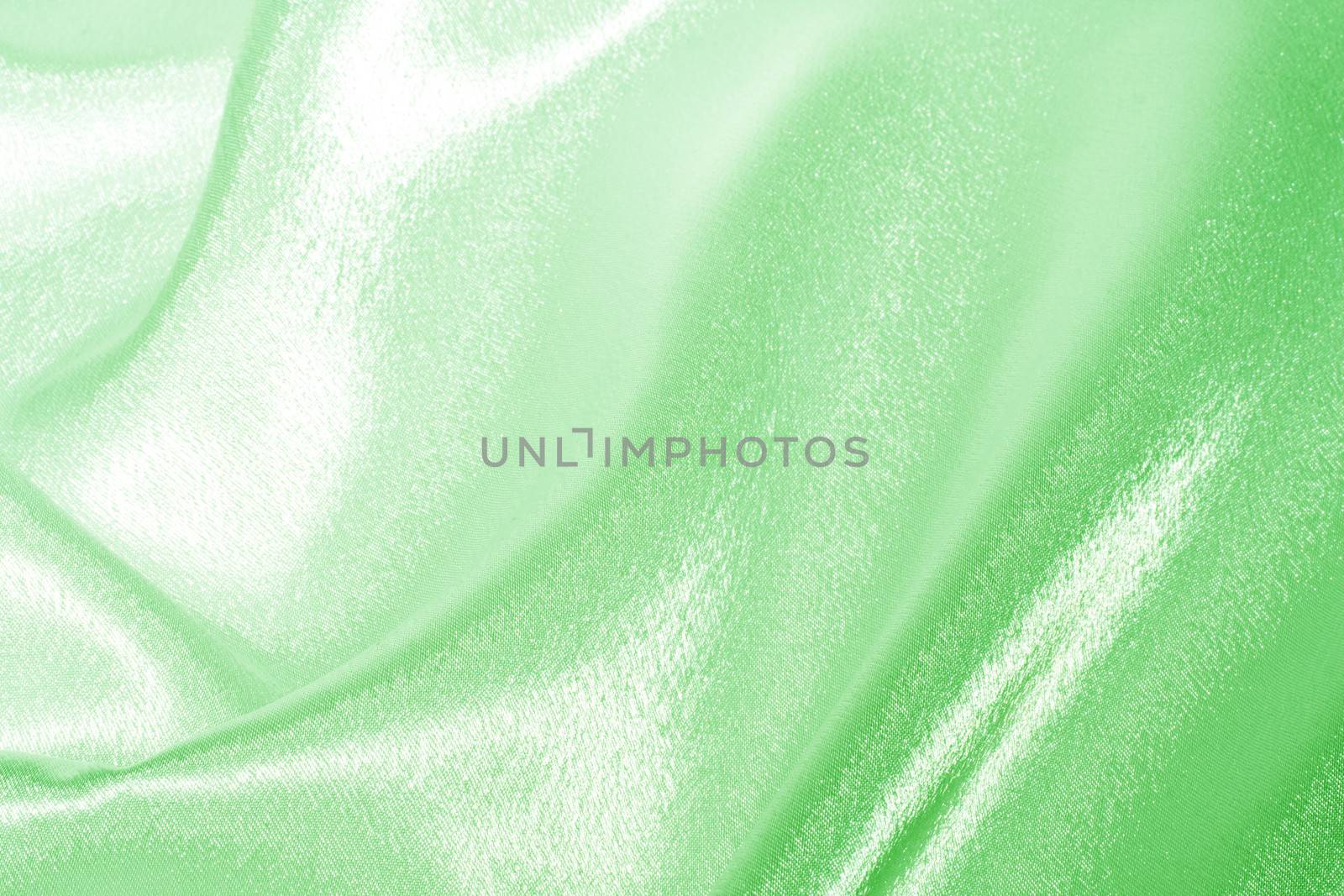 Abstract background green silk fabric with beautiful waves