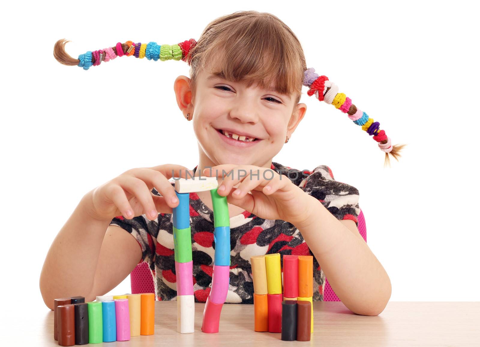 happy little girl play with plasticine by goce