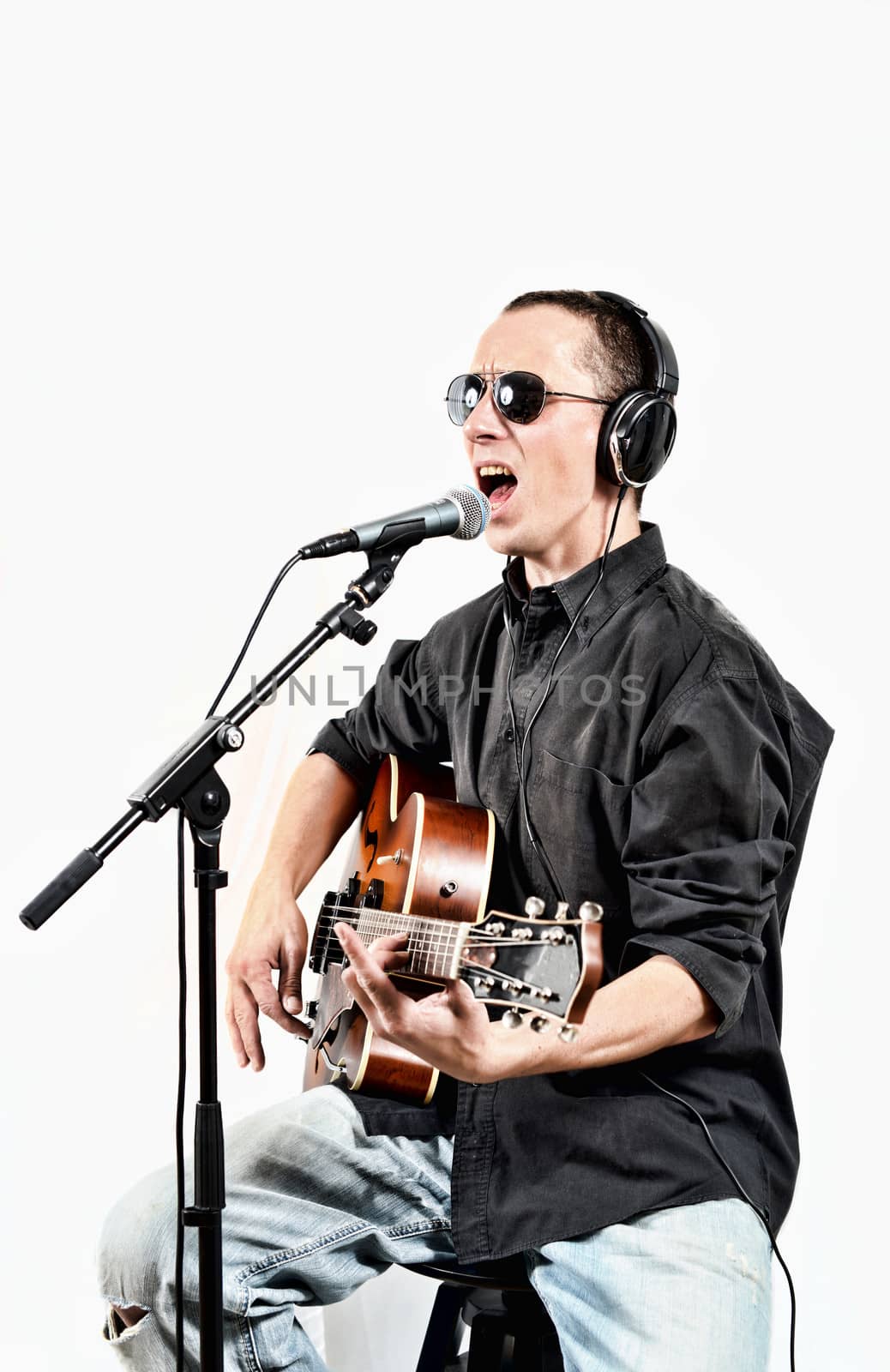 singer and his guitar sitting on a Chair