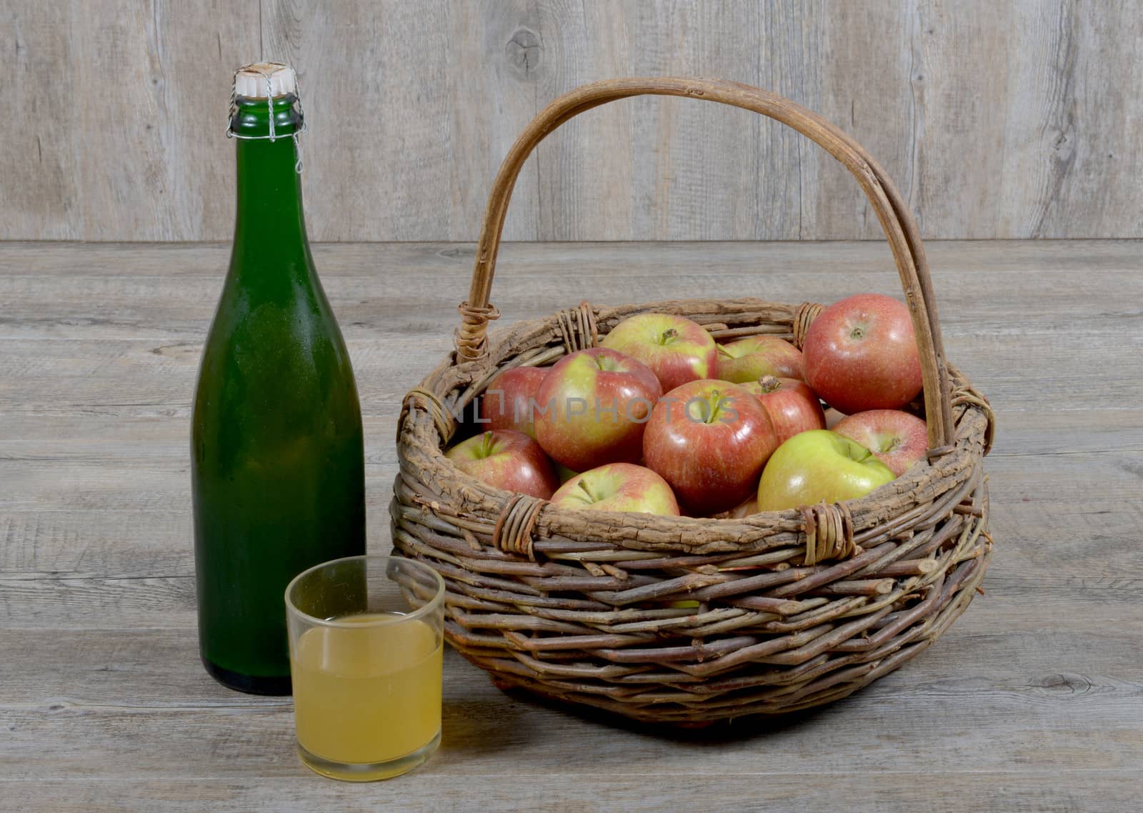 Apple basket and bottle with a glass of Norman cider
