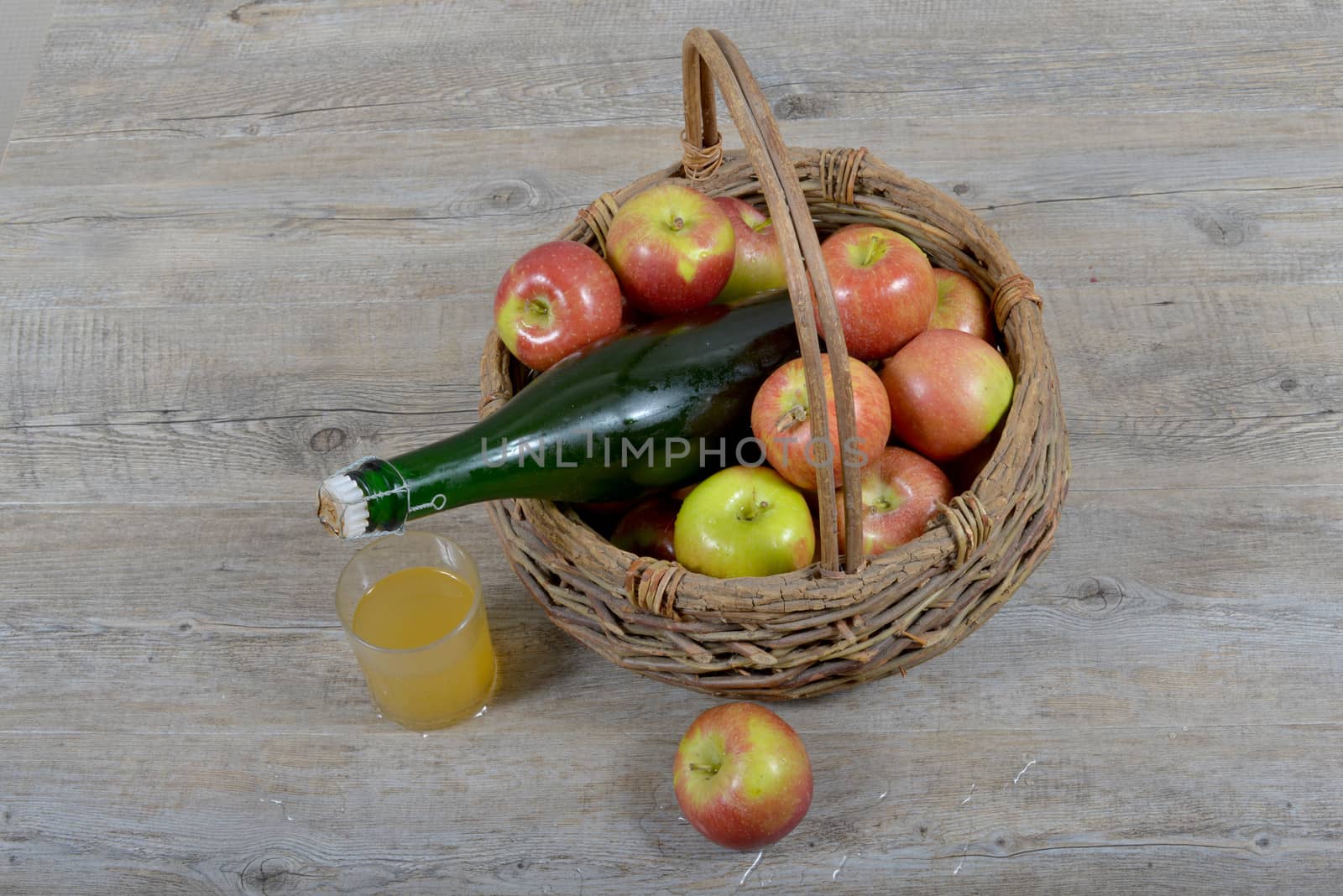 apple basket and bottle of cider. by philipimage