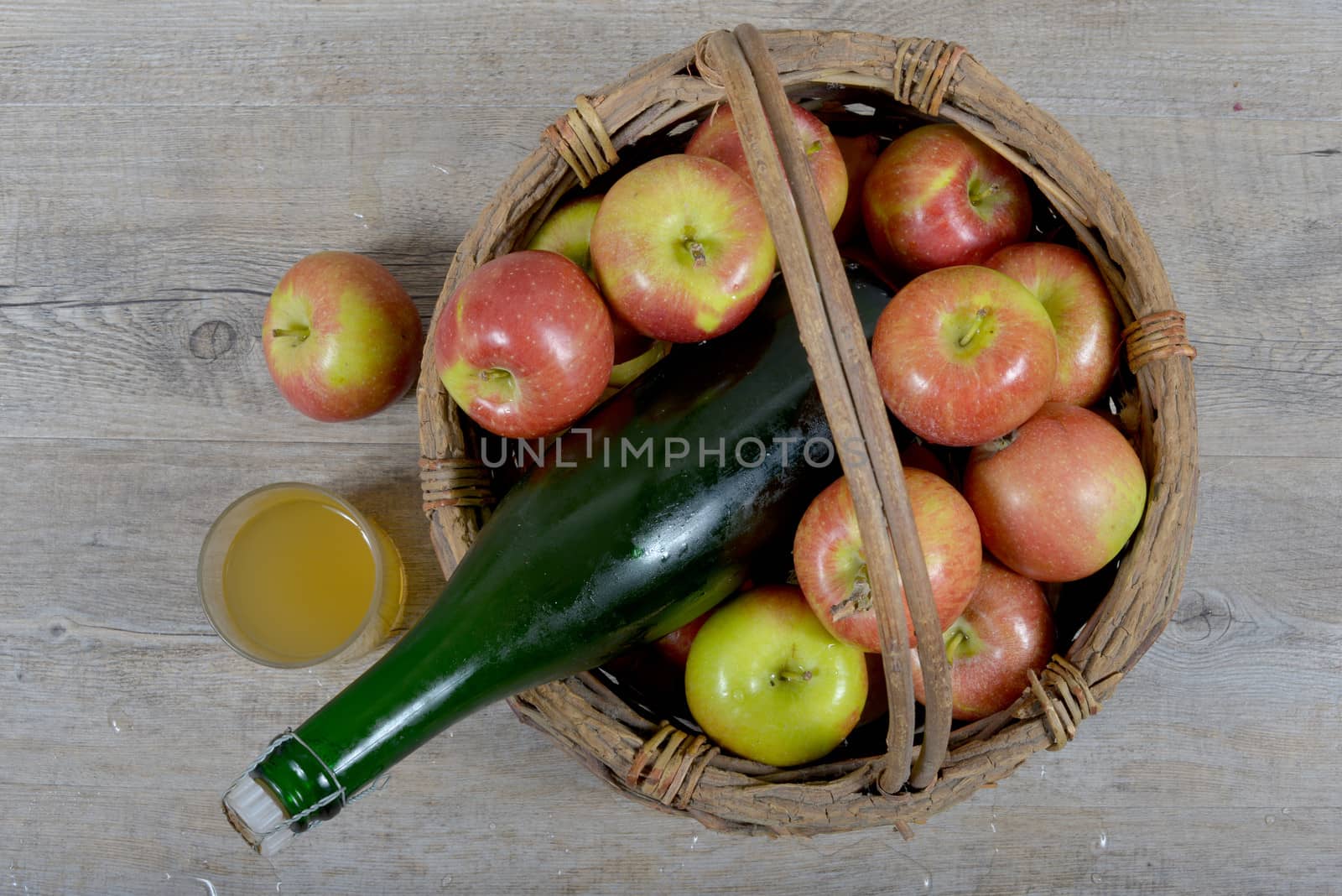 Apple basket and bottle with a glass of Norman cider