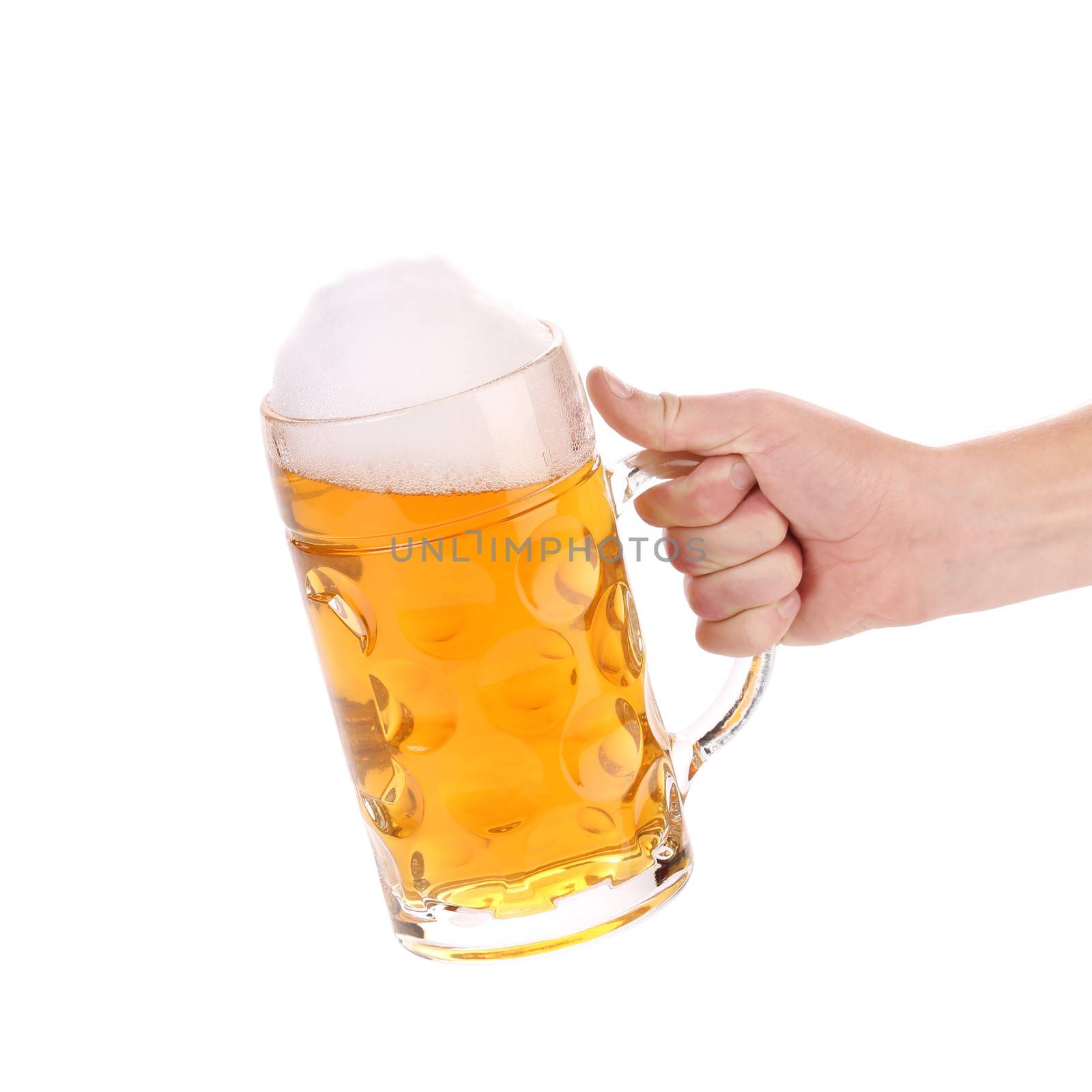 Mug of beer with froth in hand. Isolated on a white background.