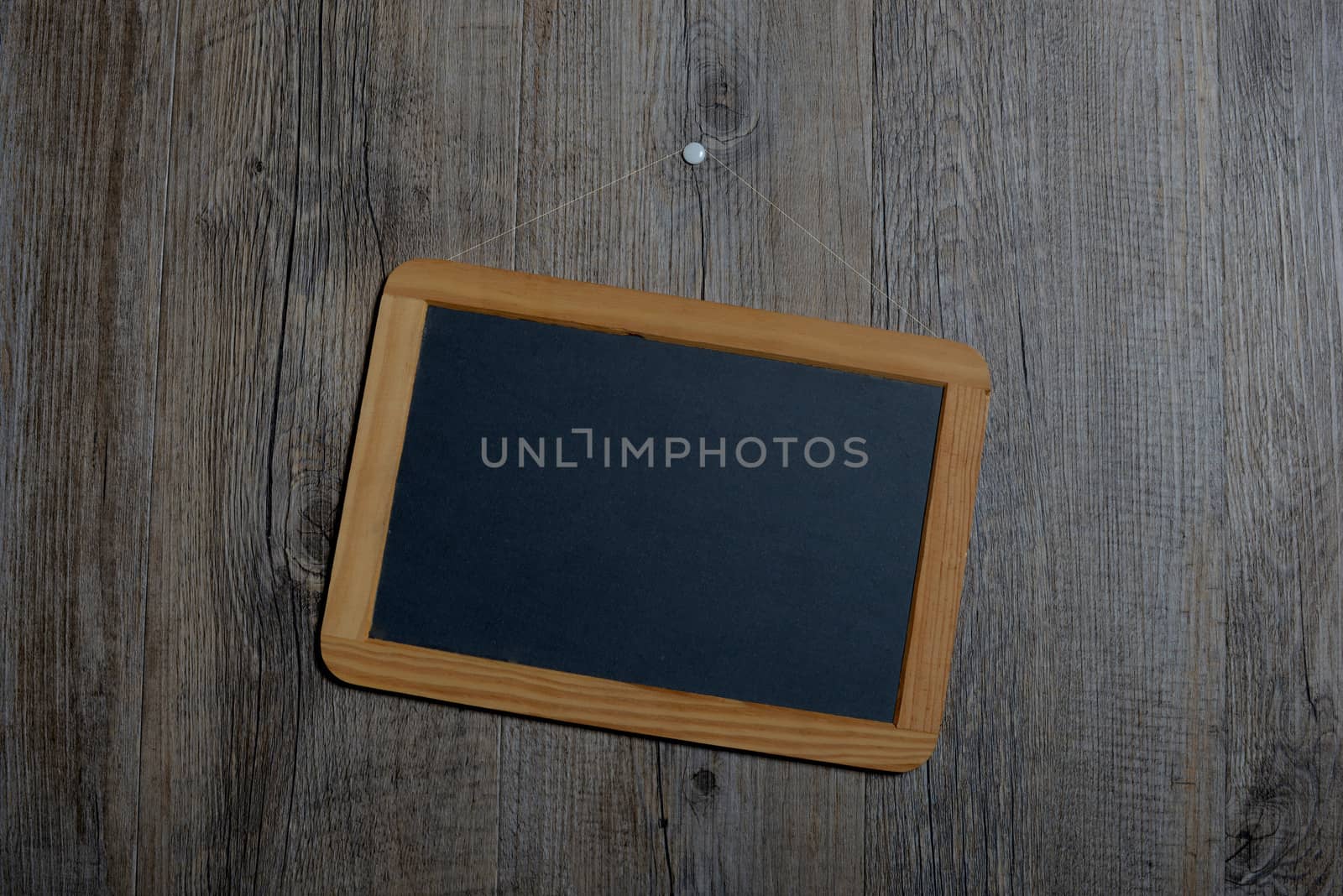 little schoolboy slate hanging on a wooden wall
