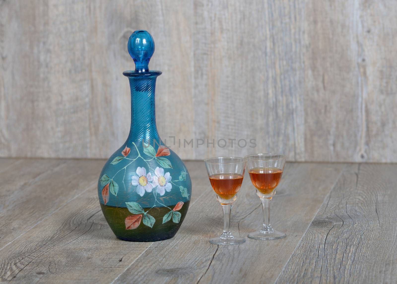 Former decanter with two small glasses with liqueur by philipimage