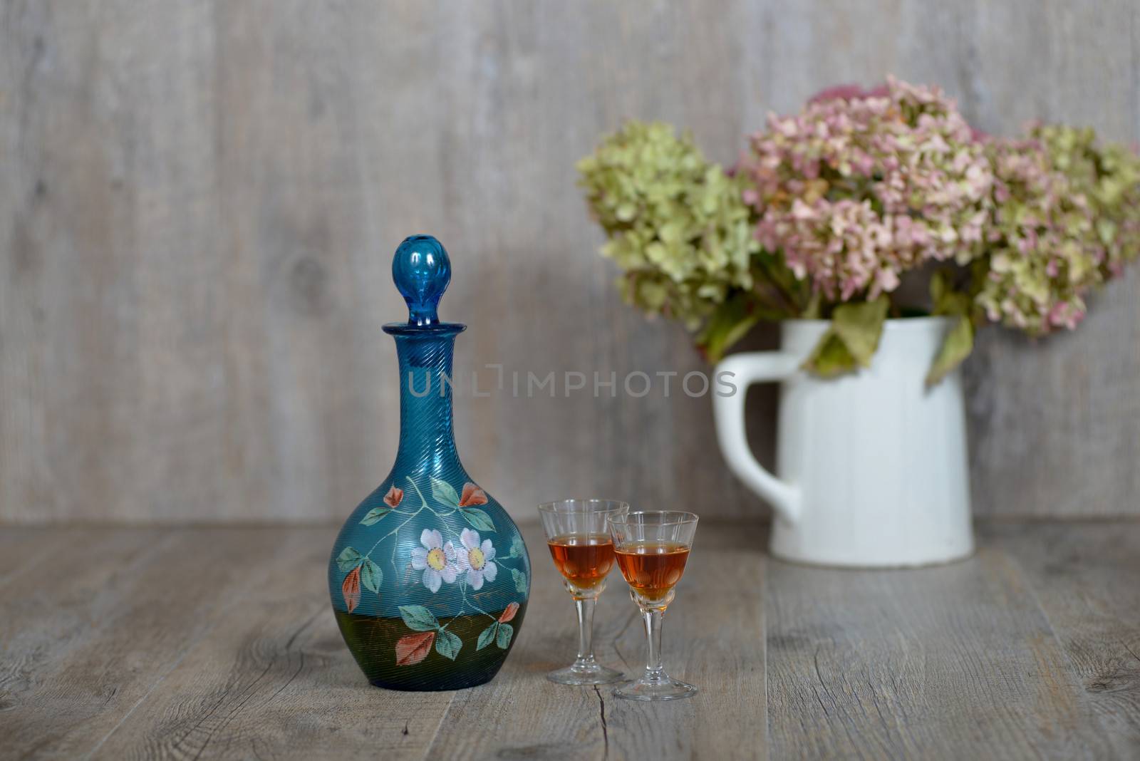 Former decanter with two small glasses with liqueur by philipimage