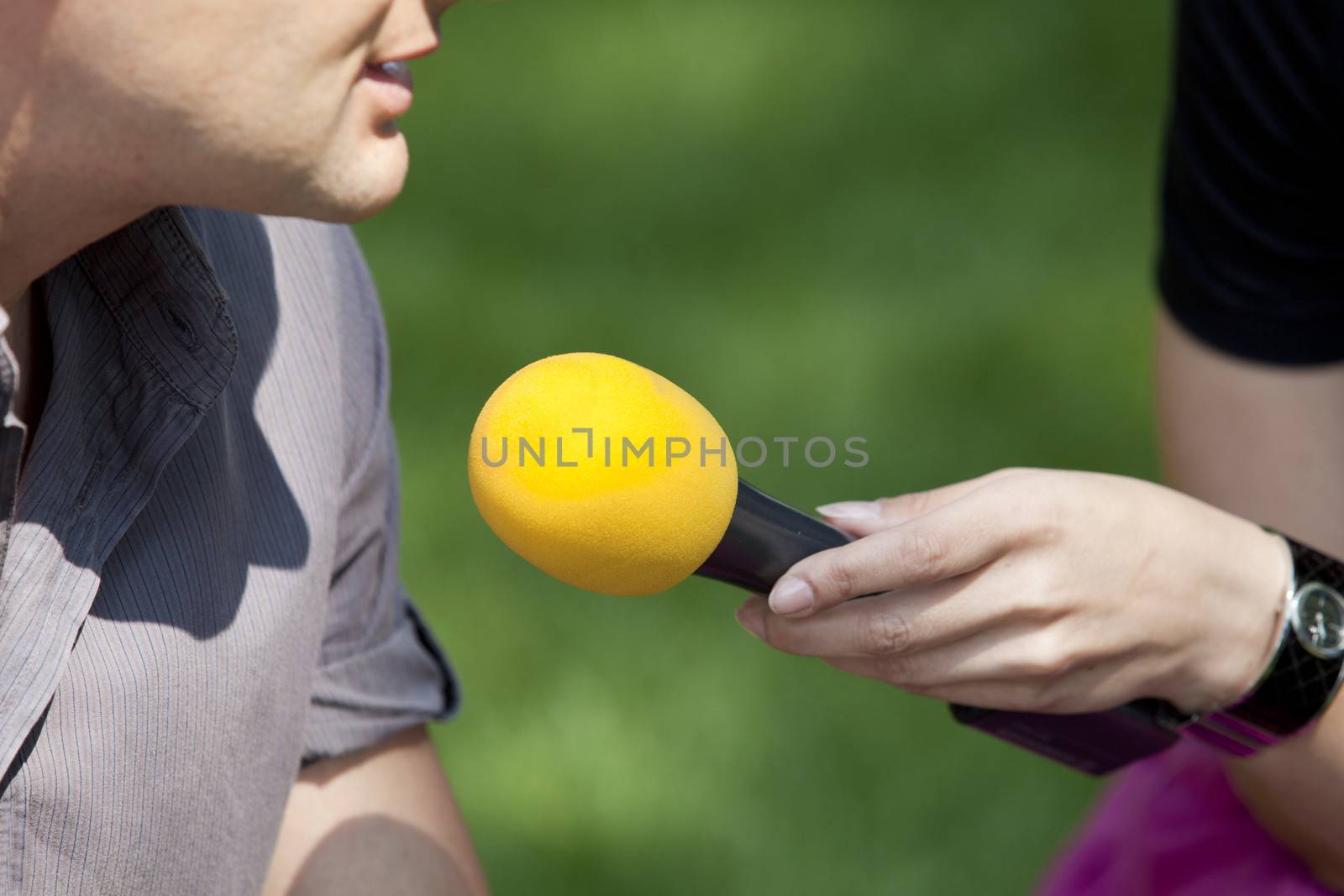 A journalist is making a interview with a microphone