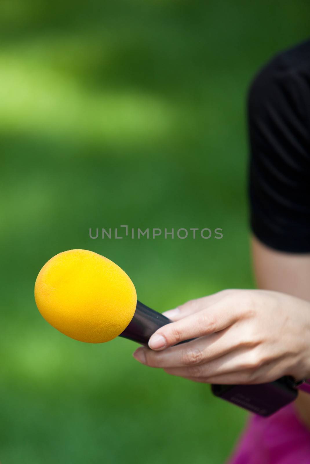 A journalist is making a interview with a microphone