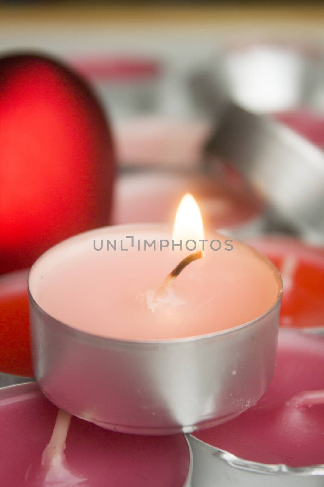 Different colors of candles in a indoor composition.