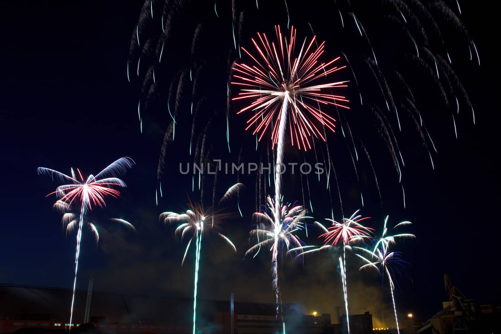 colorful fireworks into the night sky of the city