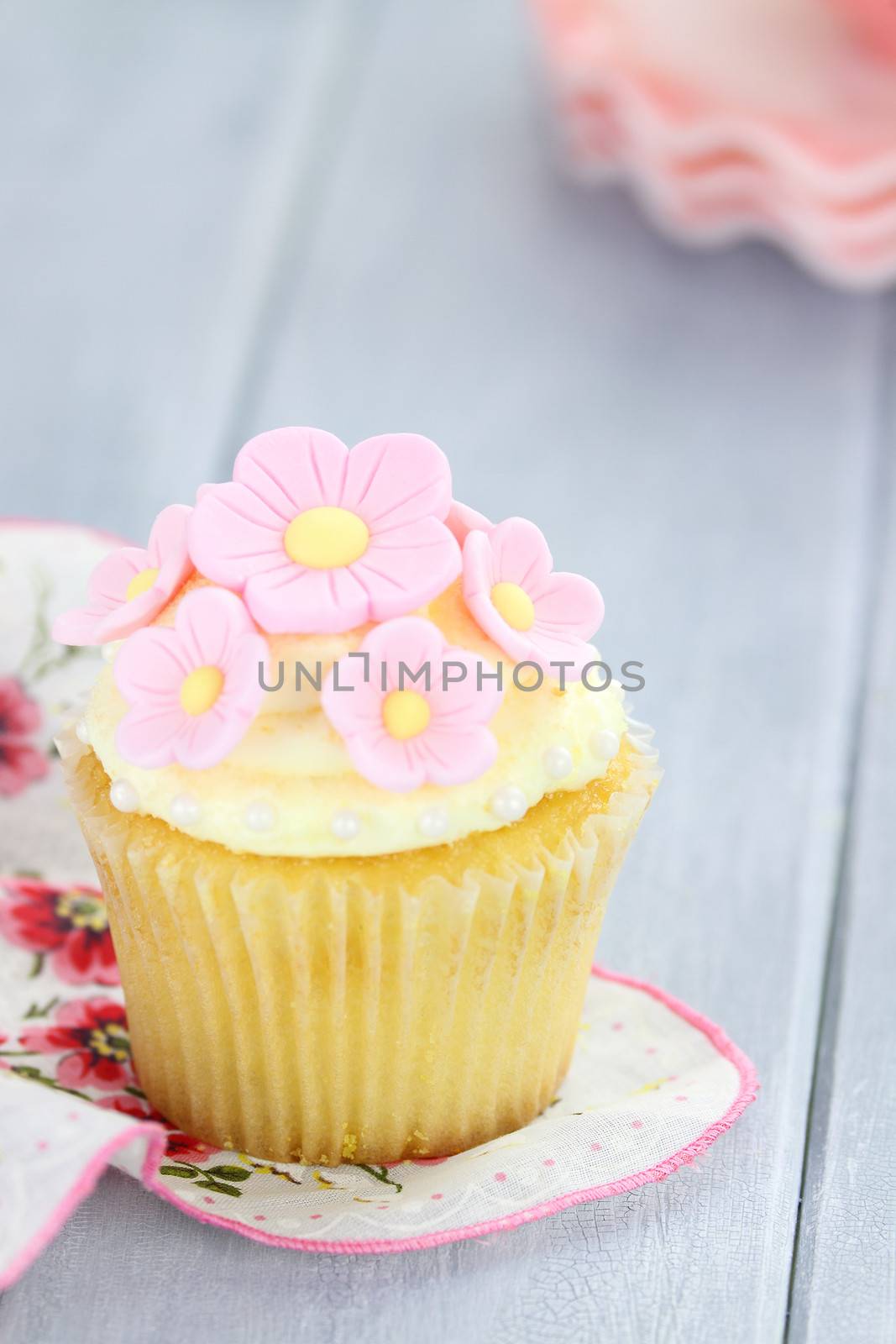 Pretty yellow and pink cupcake with extreme shallow depth of field.