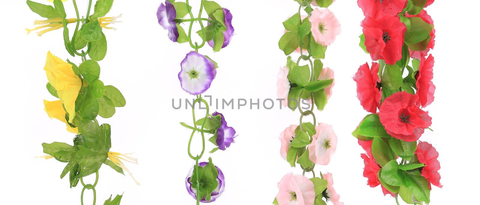 Top view of artificial flowers bunch isolated on white background.