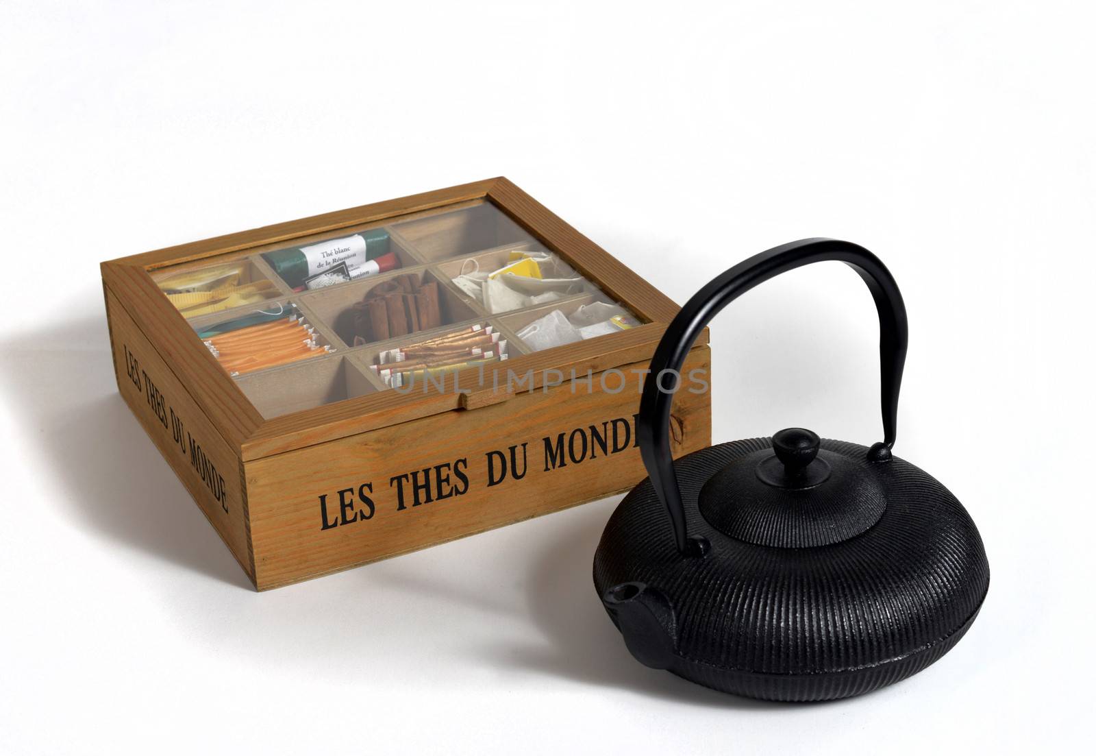 teapot and tea box on a white surface
