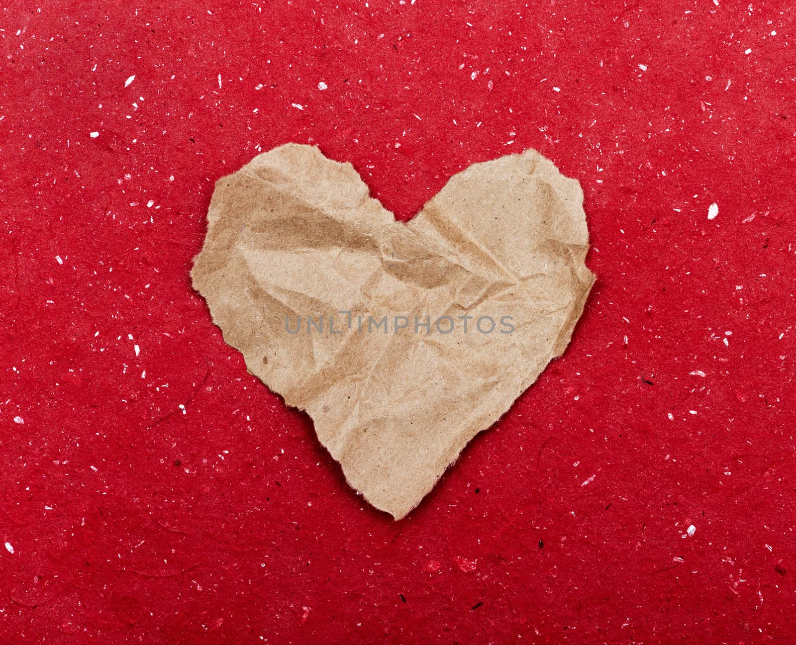 Torn paper heart on a red background