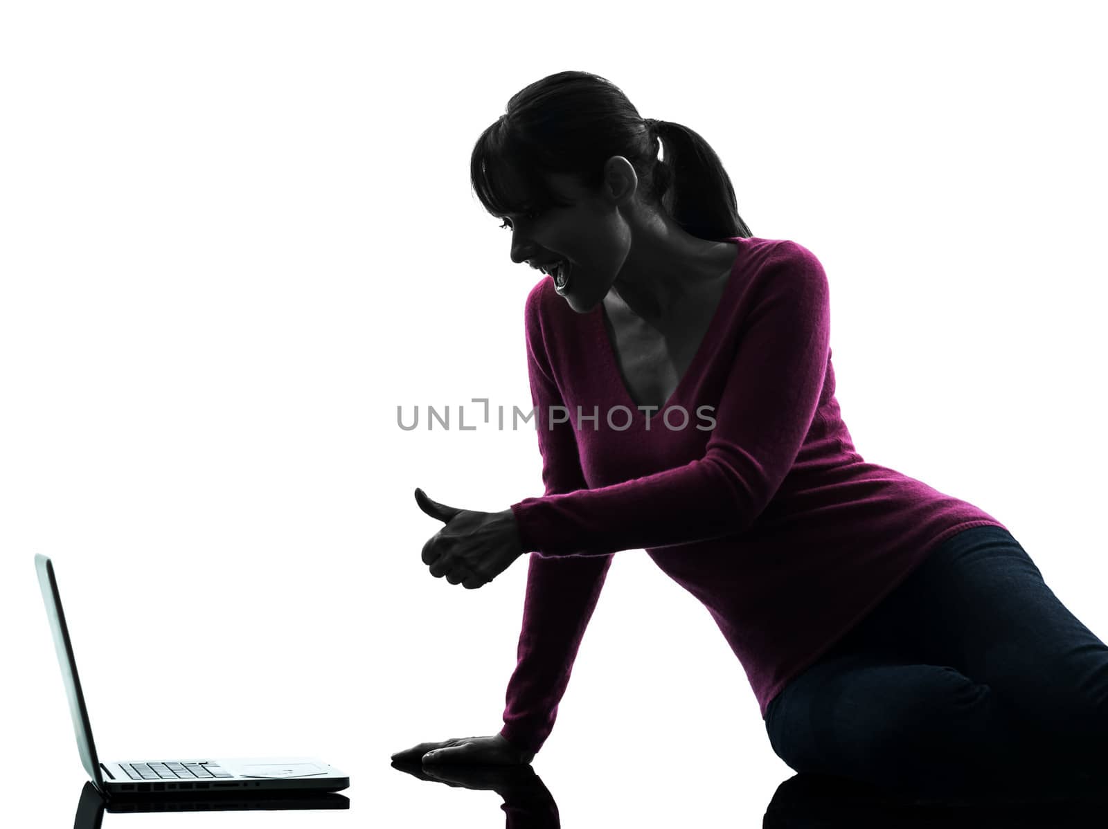 one caucasian woman thumb up computing laptop computer in silhouette studio isolated on white background