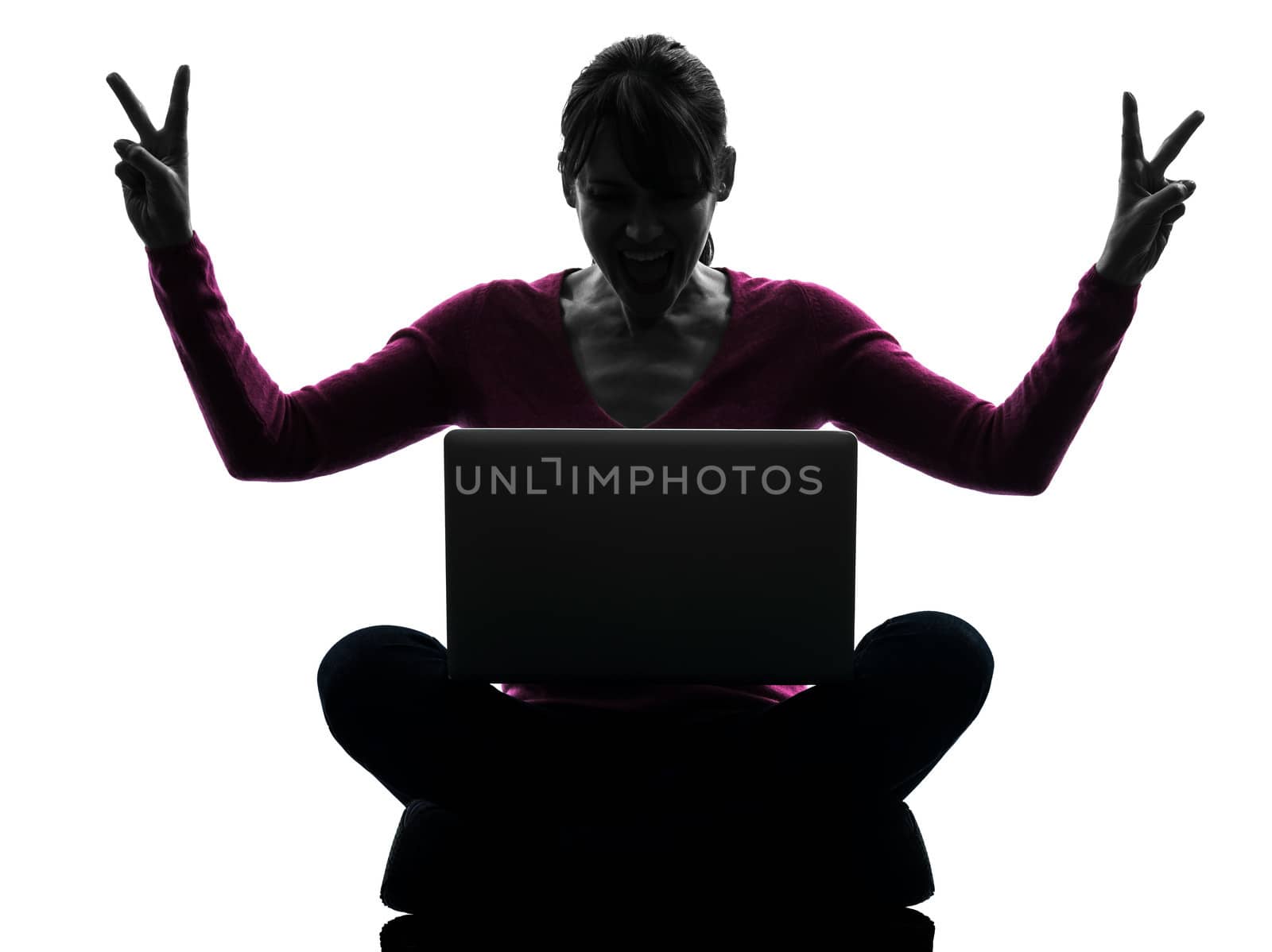 one caucasian woman happy winning computing laptop computer in silhouette studio isolated on white background