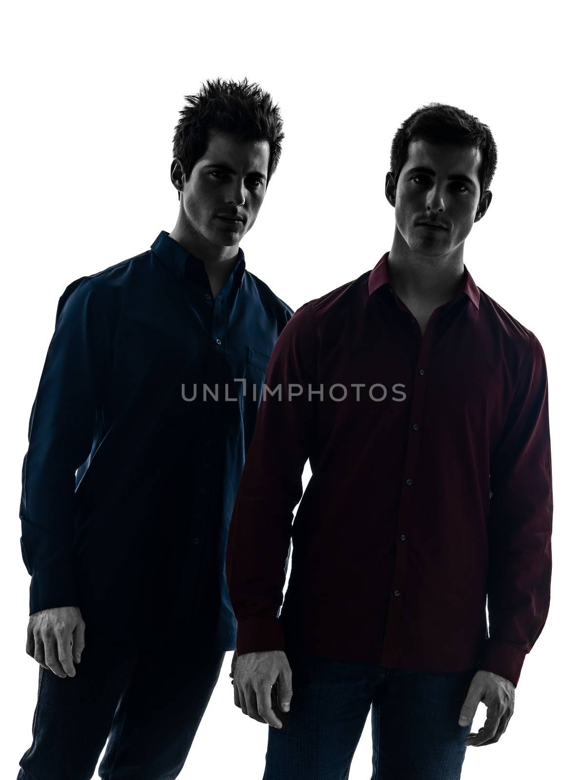 two caucasian young men standing serious in shadow white background