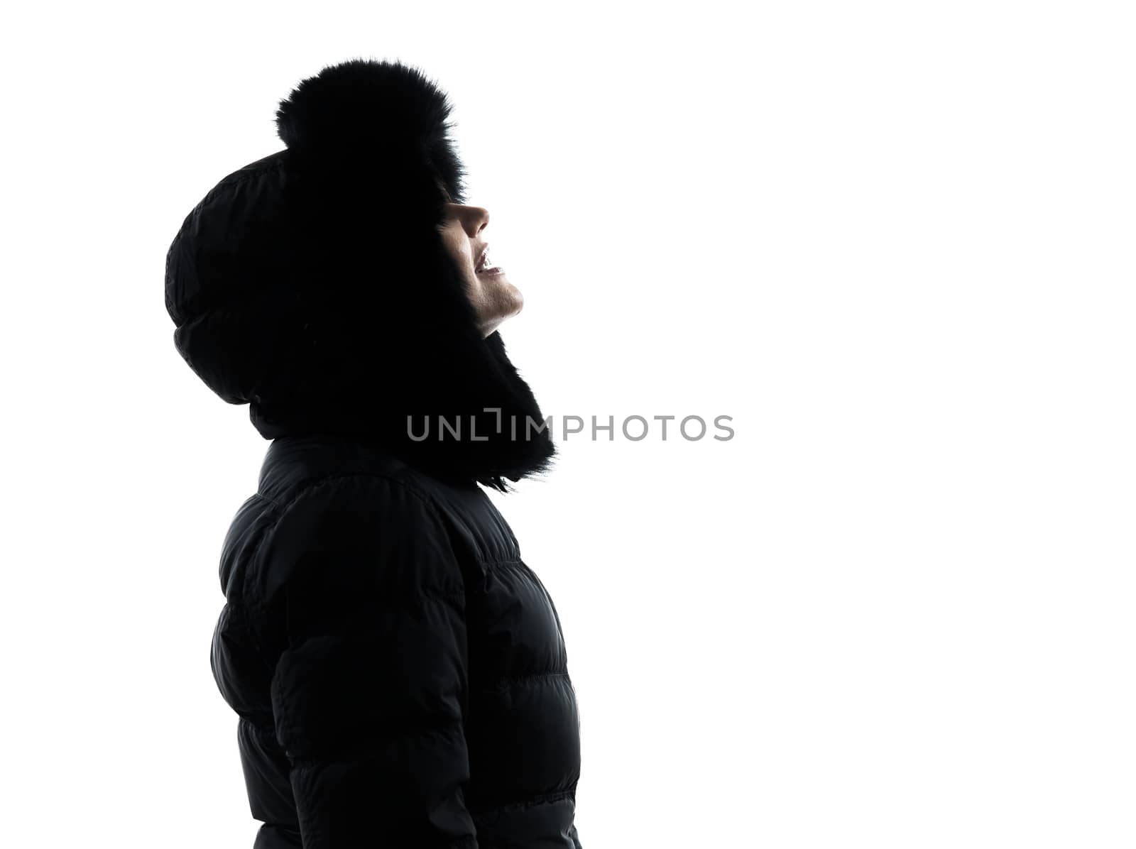 one woman in winter coat looking up smiling silhouette on white background