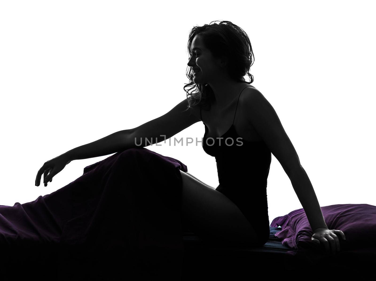 one woman smiling sitting in bed silhouette studio on white background