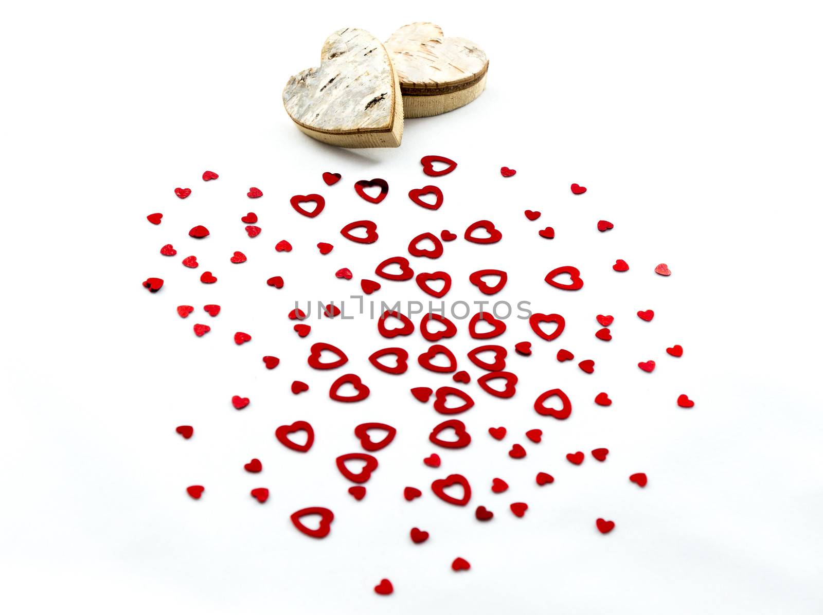 Red hearts and wooden hearts on white background for Valentines day and love concept