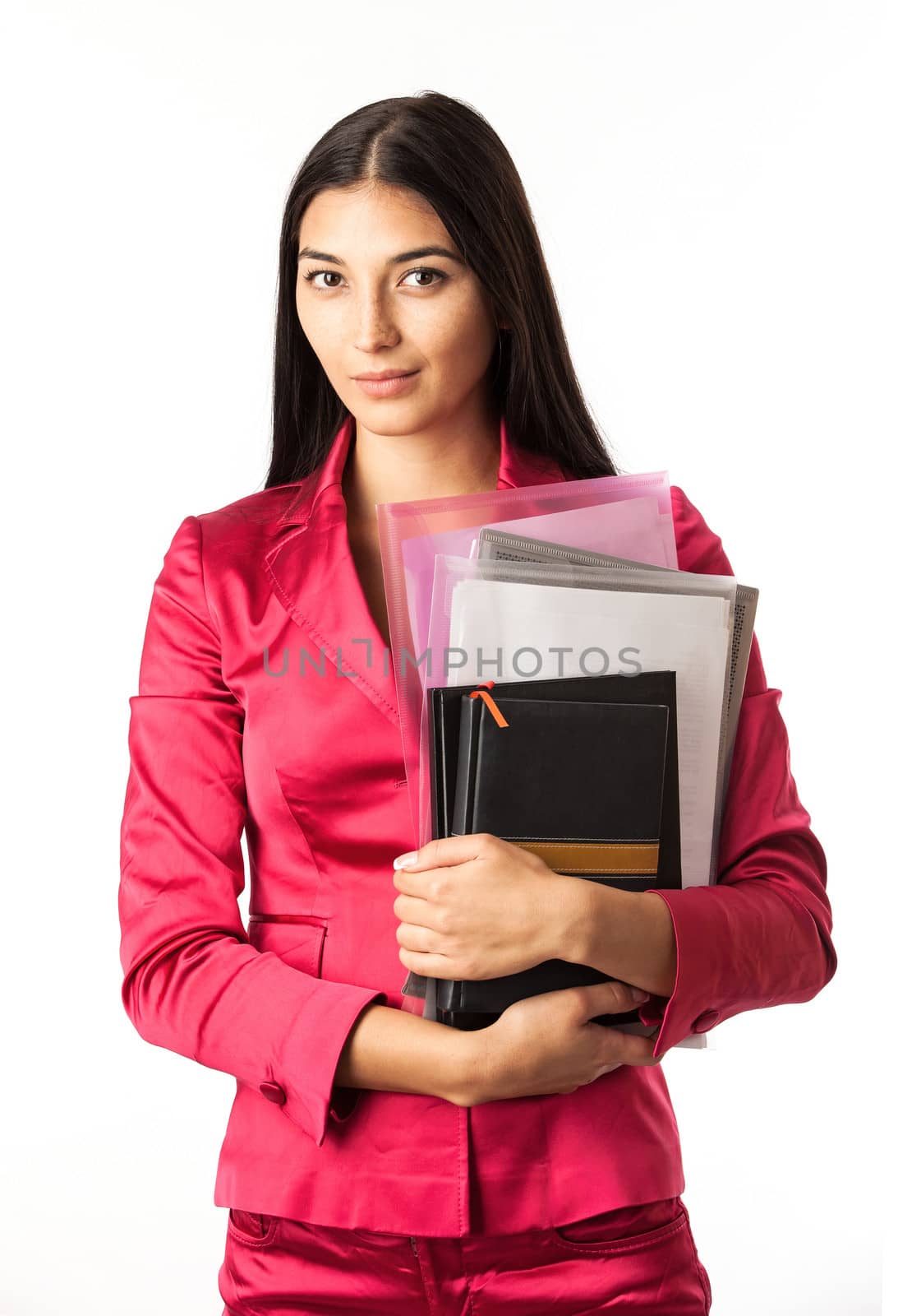 Portrait of a young beautiful girl holding files and standing against white background