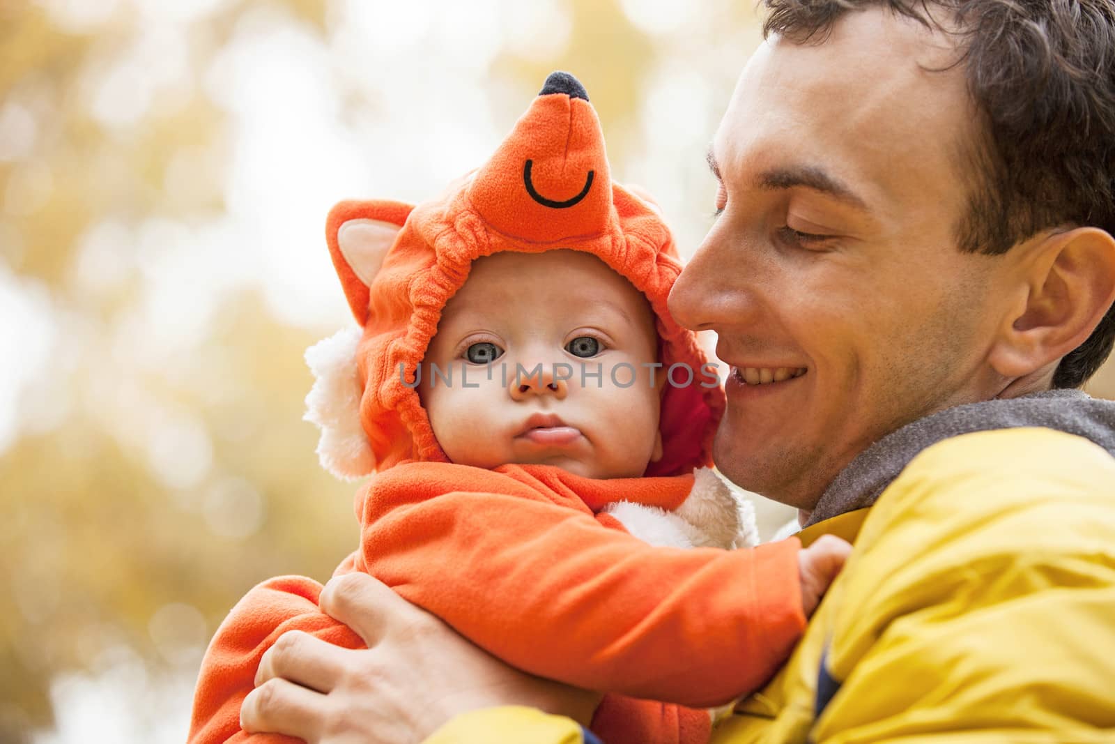 Young man and his little son in fox costume by photobac