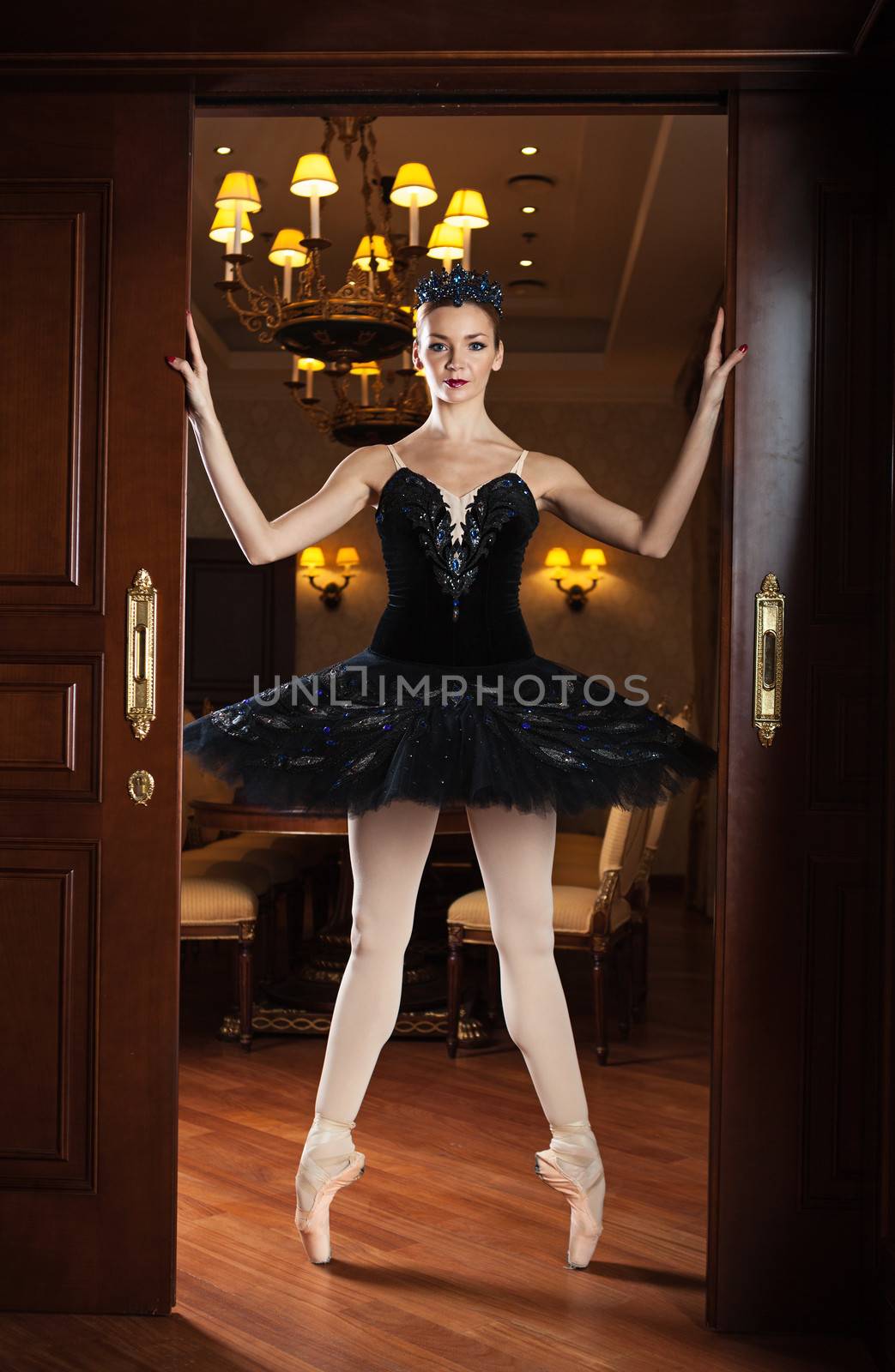 Ballerina in black tutu standing on pointes by photobac