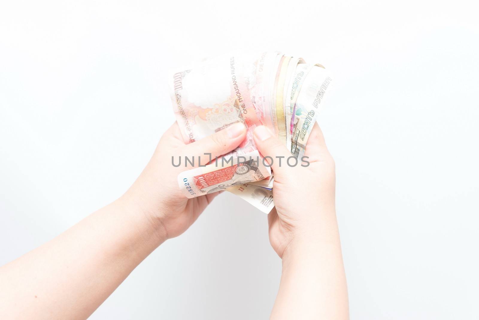 Asian woman holding multiple bank notes by sasilsolutions