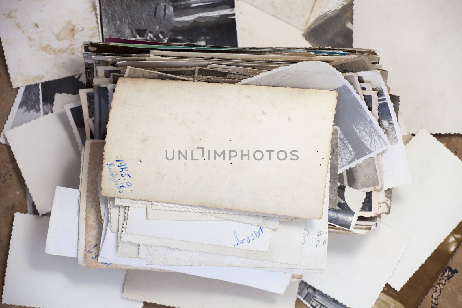 Stack of old photos with one turned up photo for your image or copy.