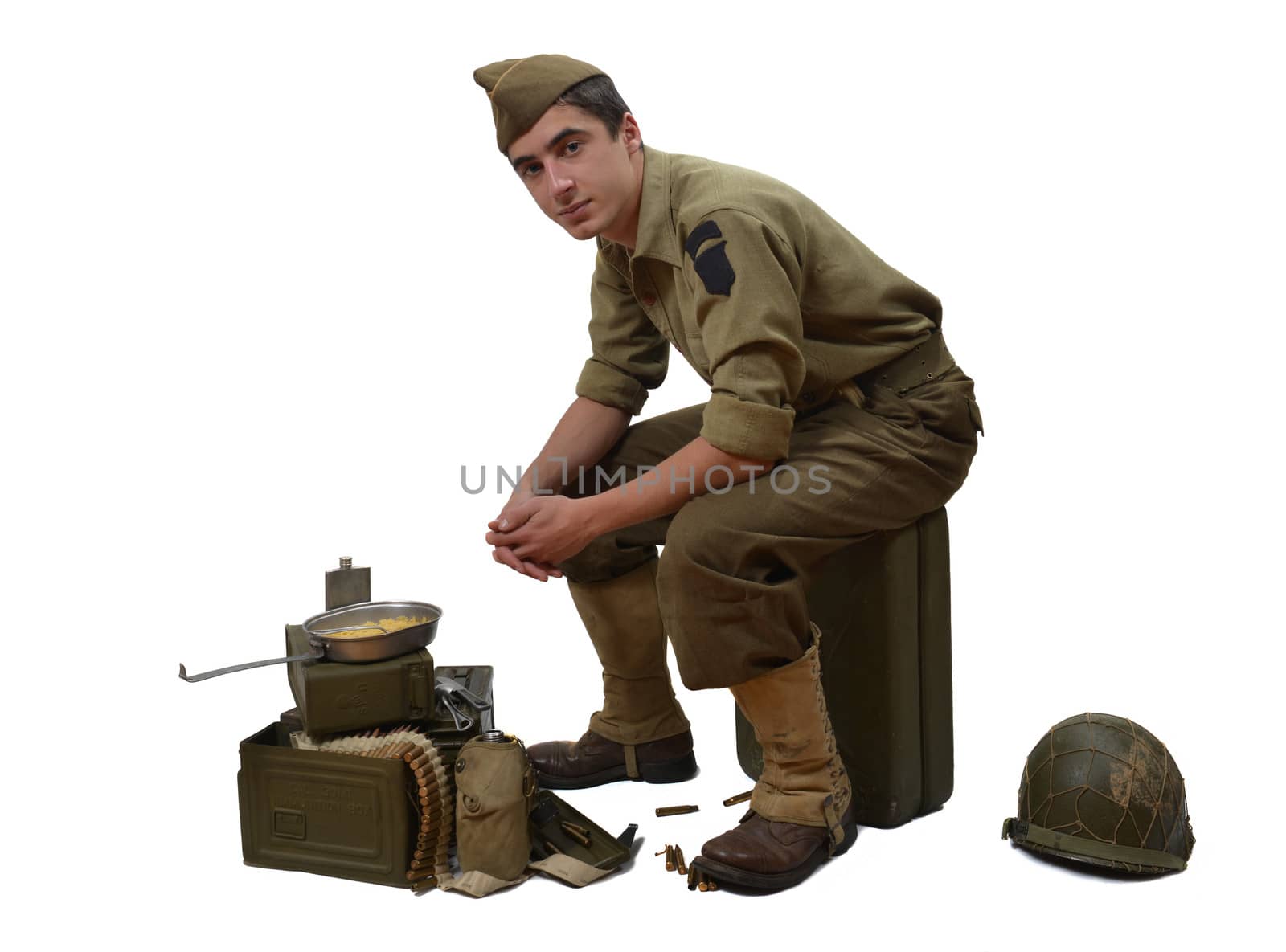 American soldier sitting on a jerrycan, he eats his meals 