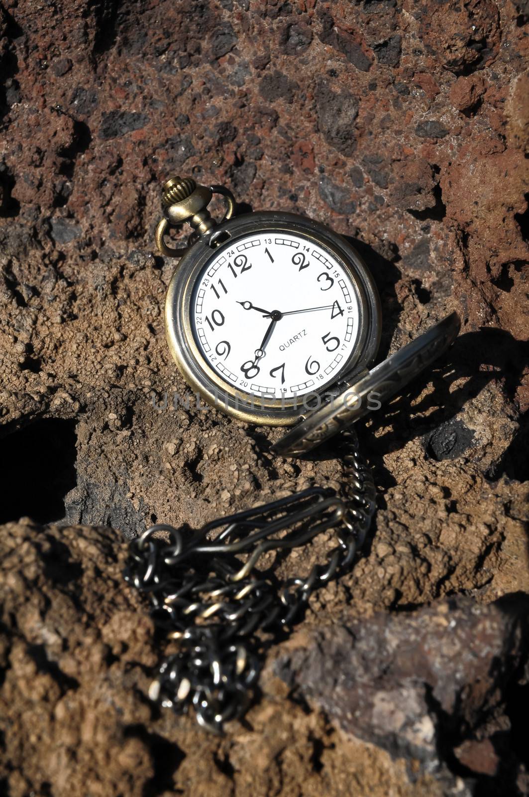 Time Concept Classic Vintage Pocket Clock on the Volcanic Rocks