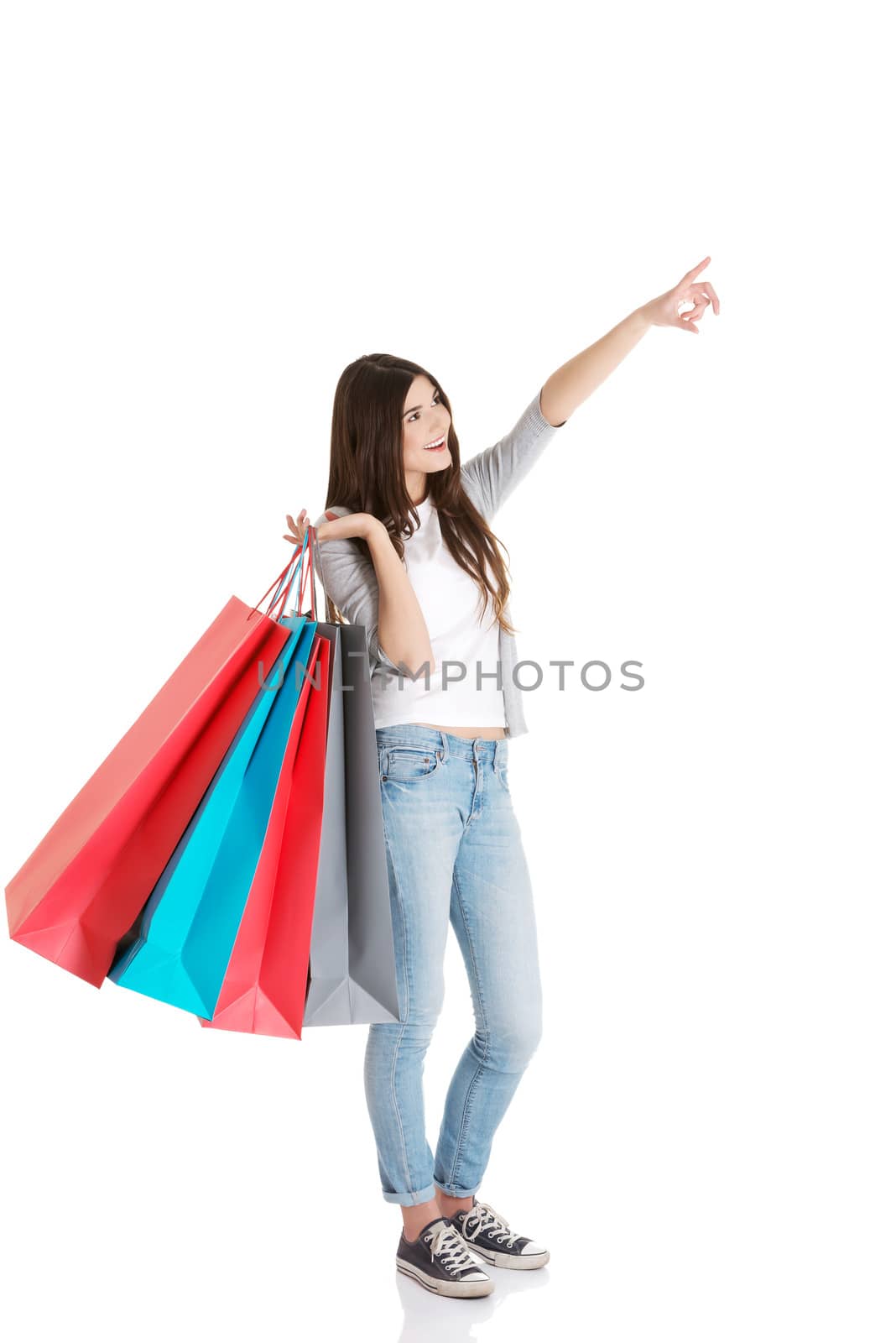 Young beautiful woman is shopping. Isolated on white.