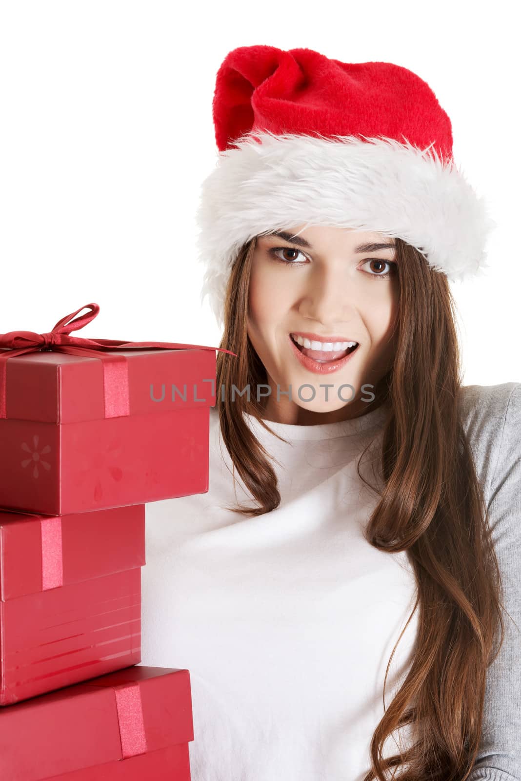 Young beautiful woman in santa hat with presents. Isolated on white.