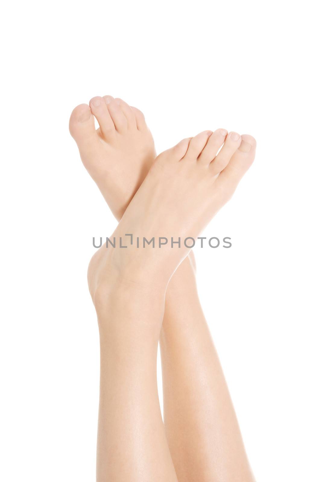 Beautiful bare woman's feet. Isolated on white.