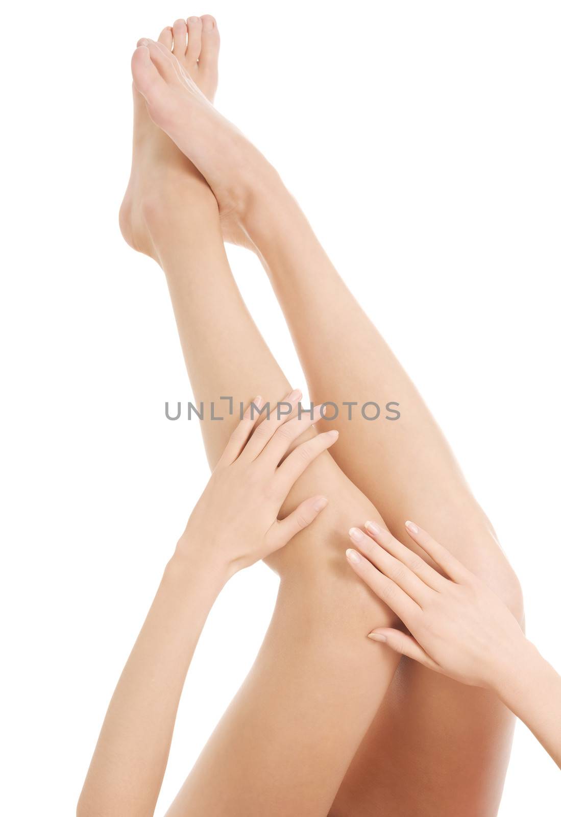 Beautiful smooth female legs streteched up. Isolated on white.