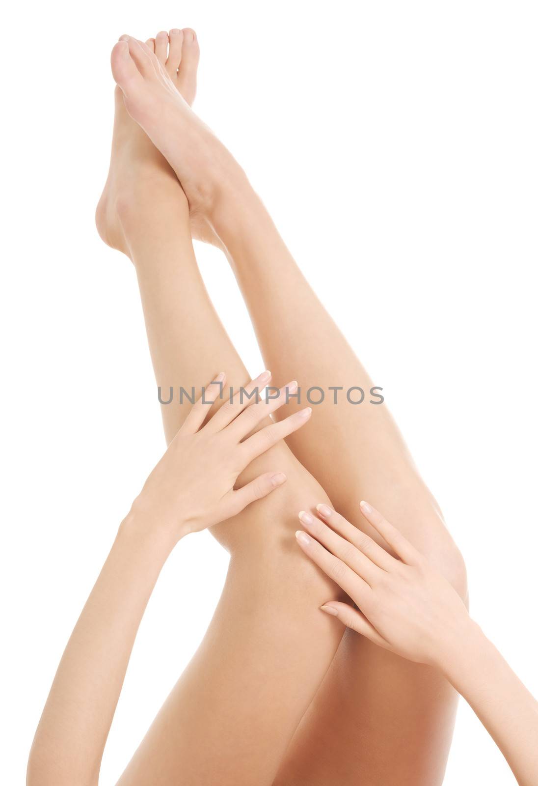 Beautiful smooth female legs streteched up. Isolated on white.