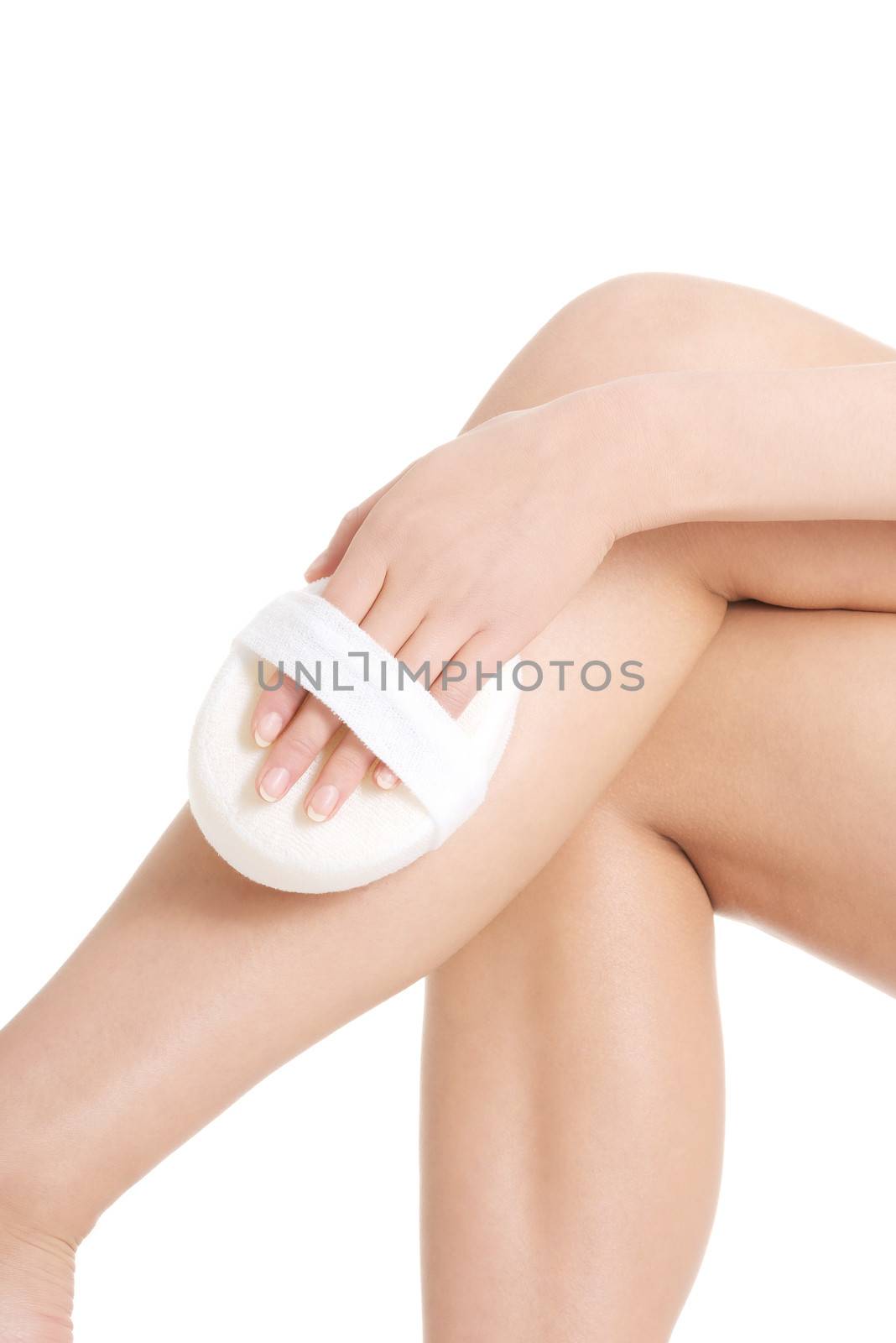 Beautiful woman's legs. Woman is pampering herself. Isolated on white.