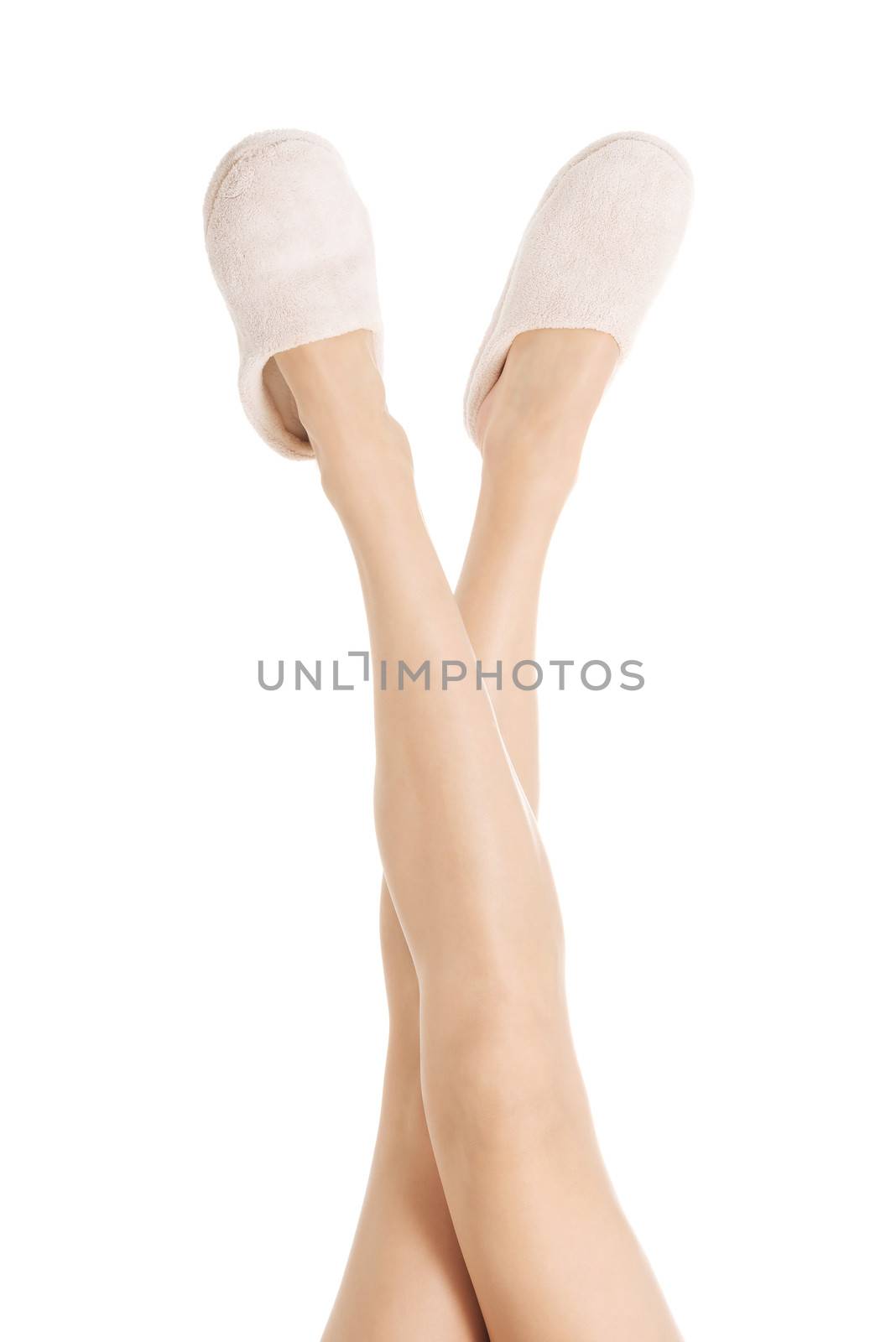 Female's feet with white slippers. Spa concept, pampering. Isolated on white.