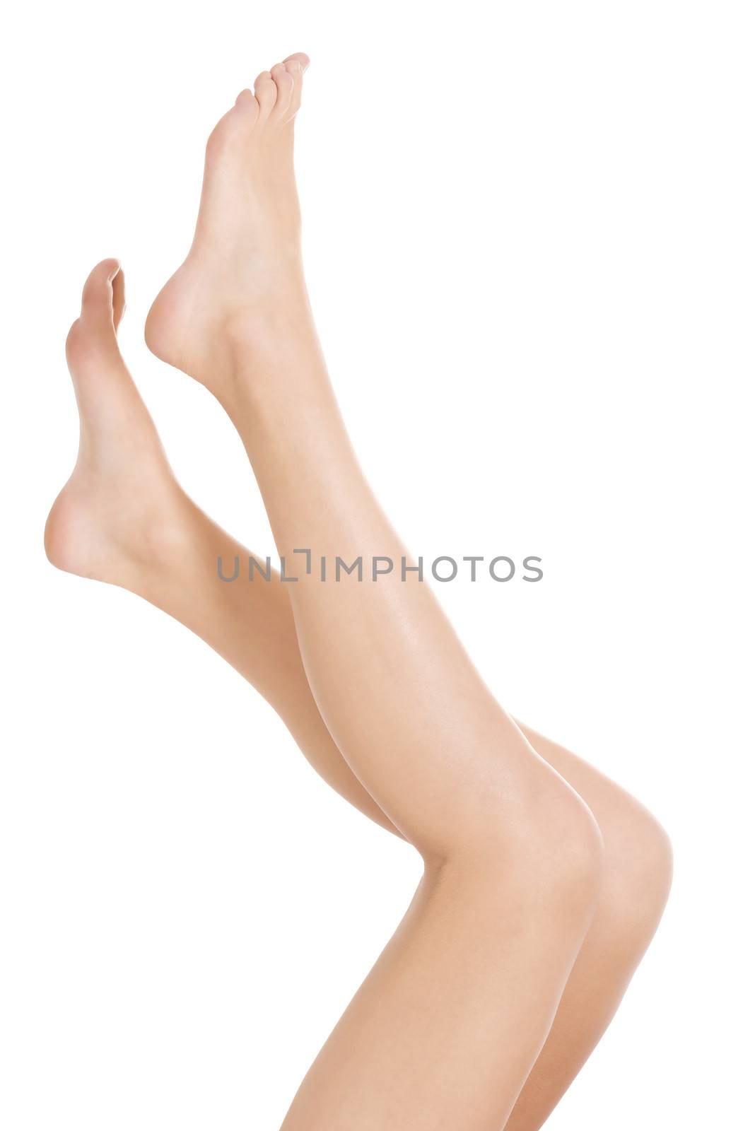 Beautiful smooth and shaved legs stretched up. Isolated on white.