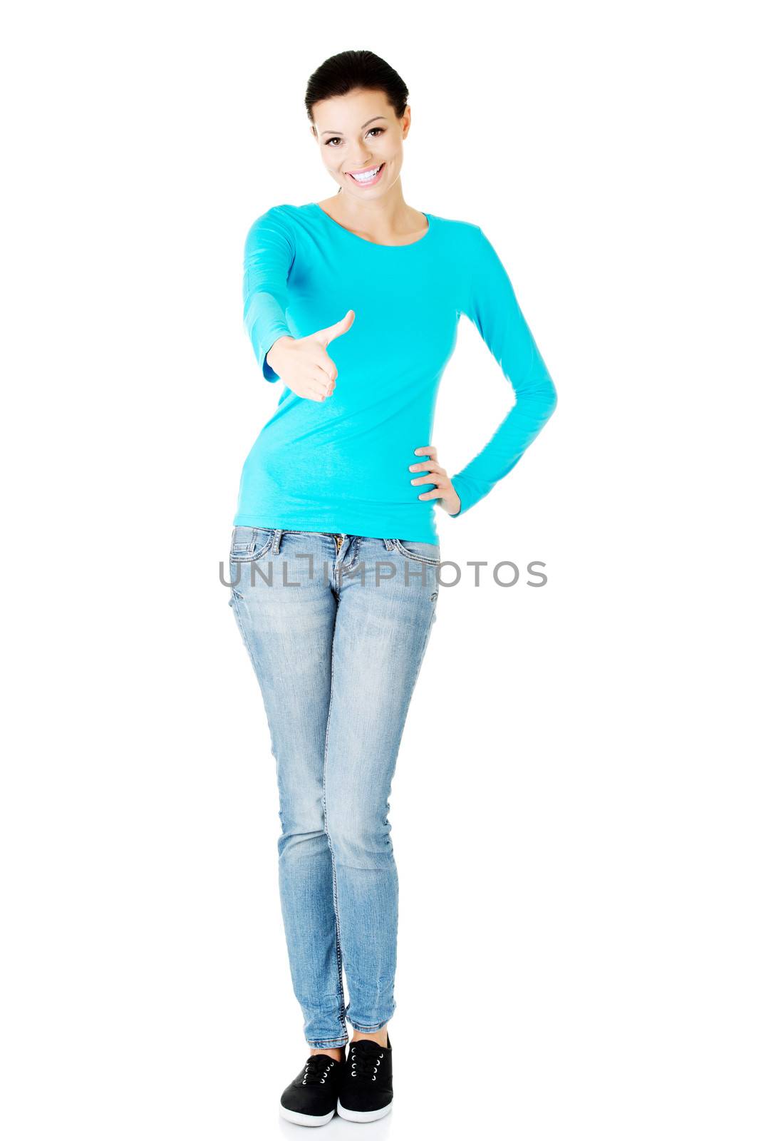 Young casual woman showing welcome gesture. Giving a hand. Isolated on white.