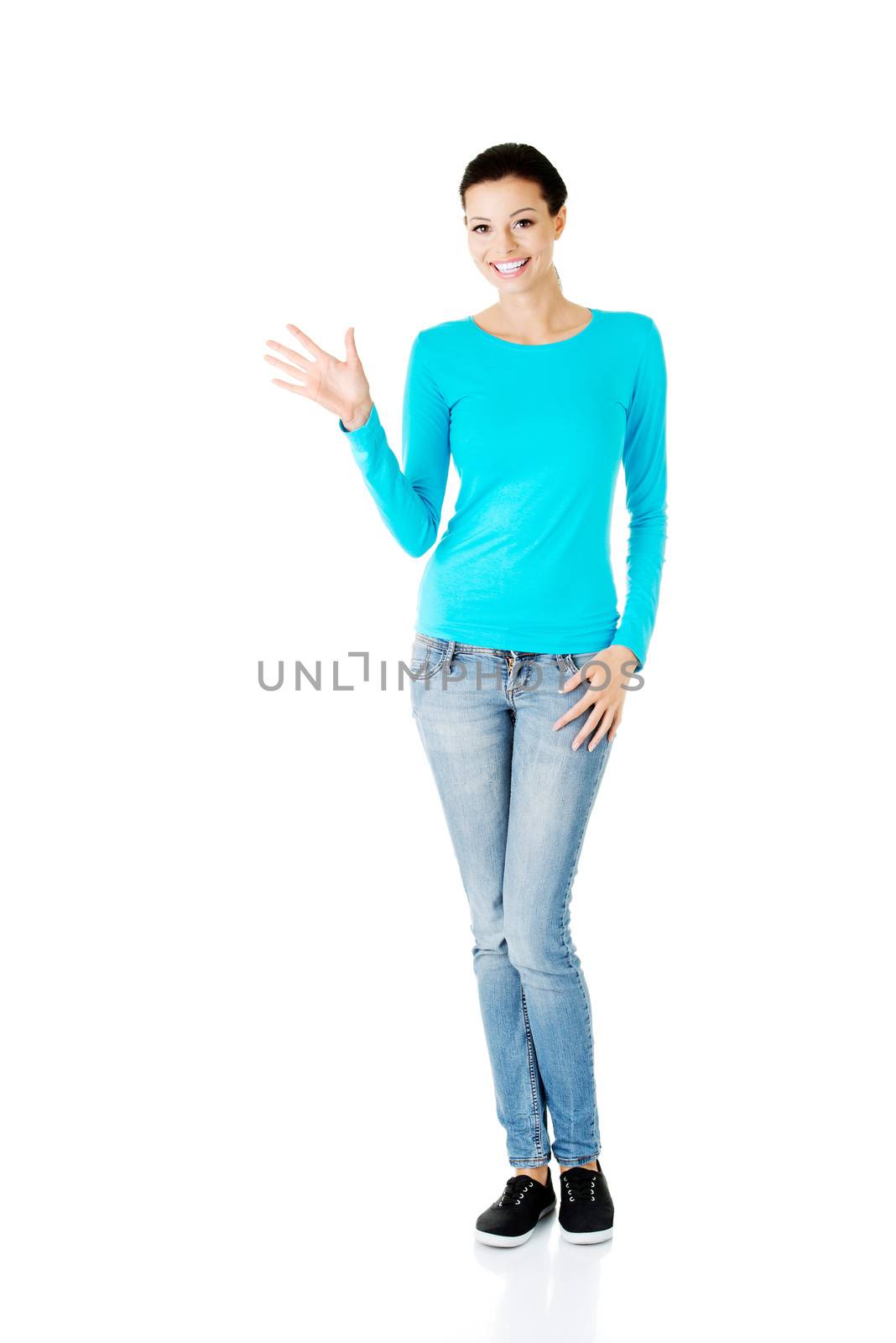 Young casual woman showing welcome gesture. by BDS