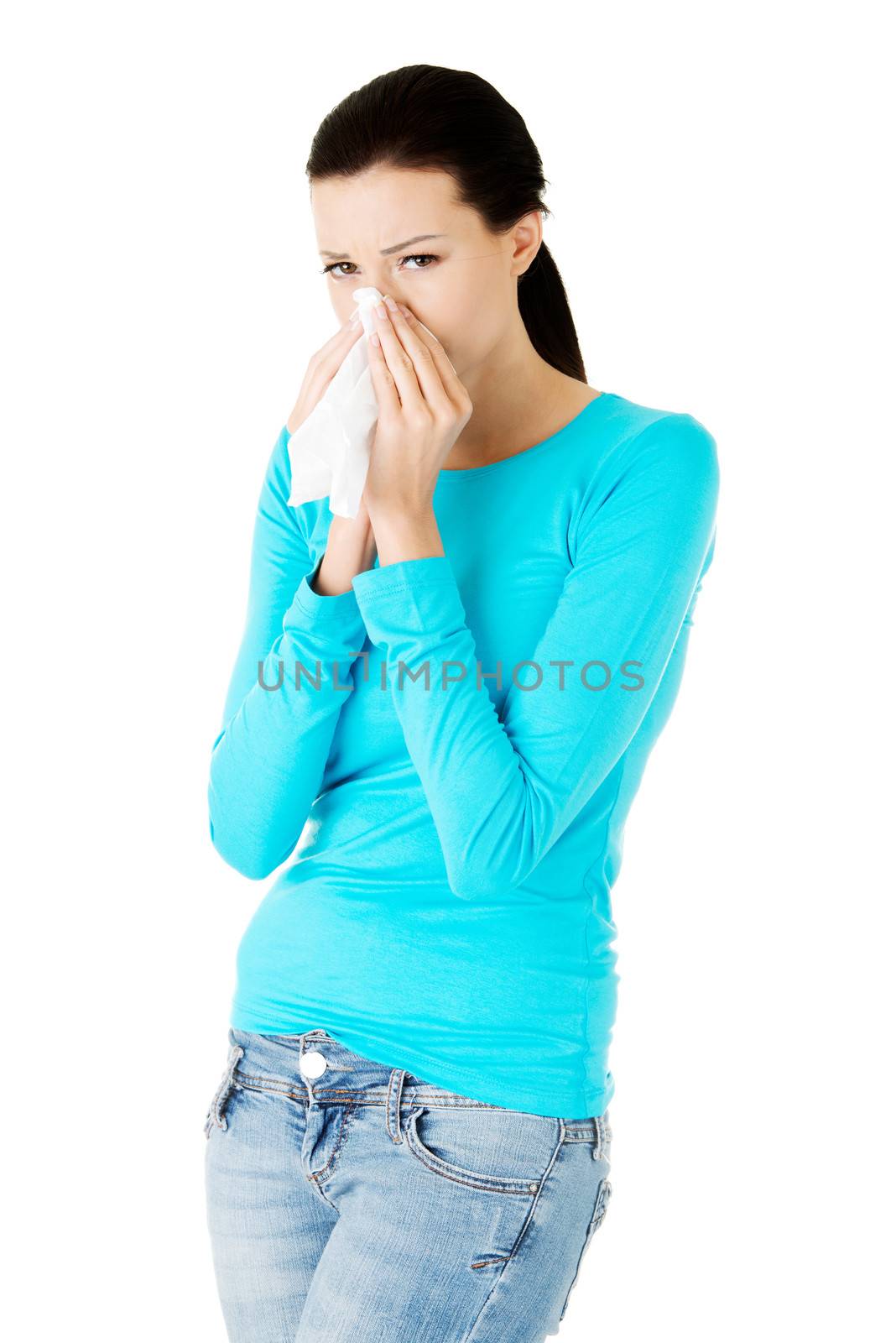 Young casual woman with tissue. Isolated on white.