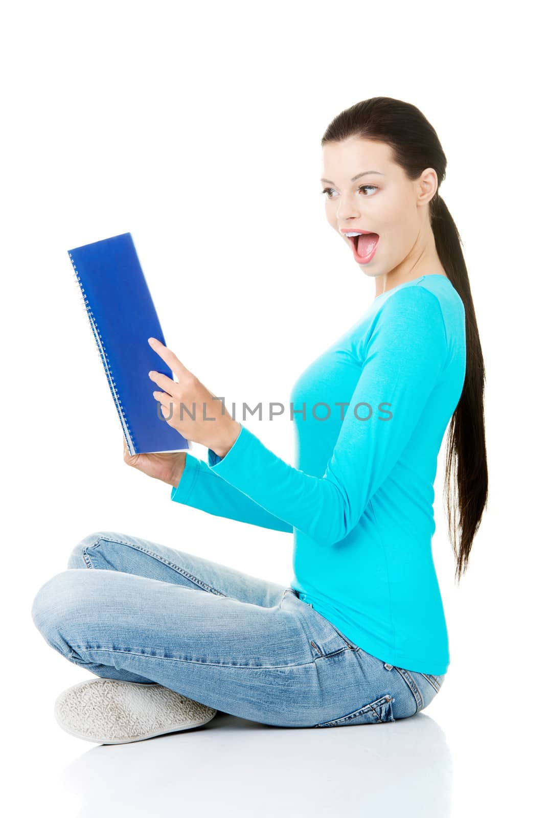 Beautiful young woman student with workbook. by BDS