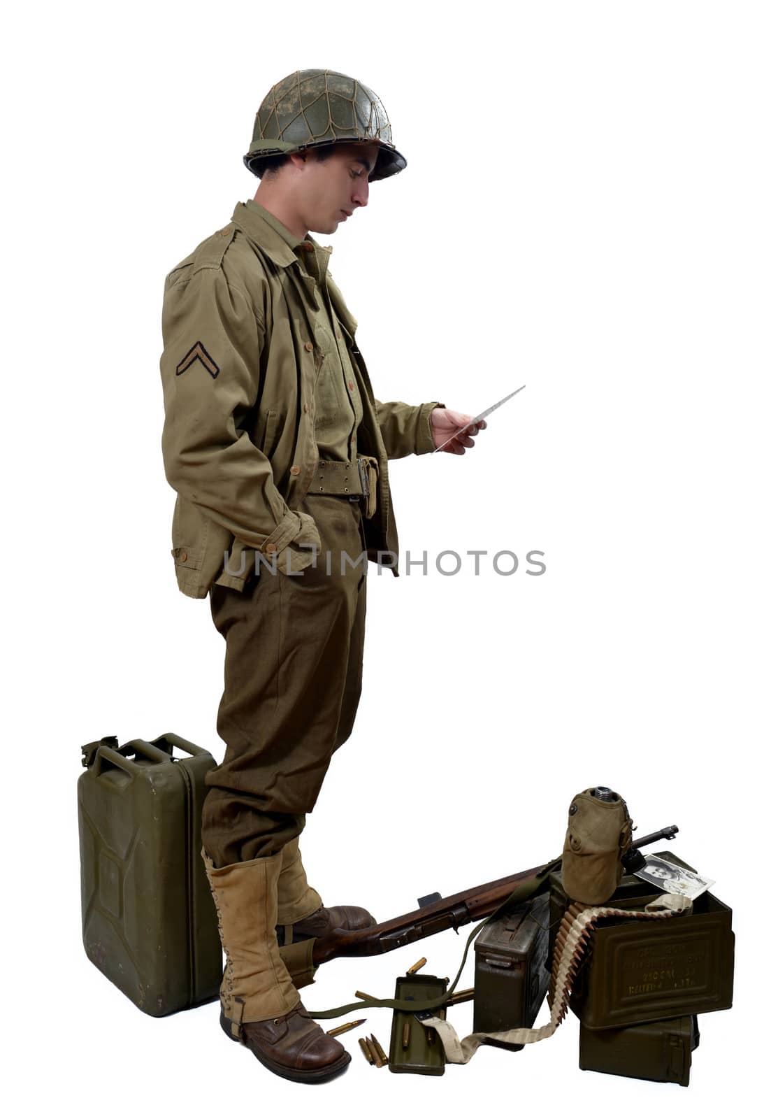 young American soldierwith his M1 carbine read a letter
