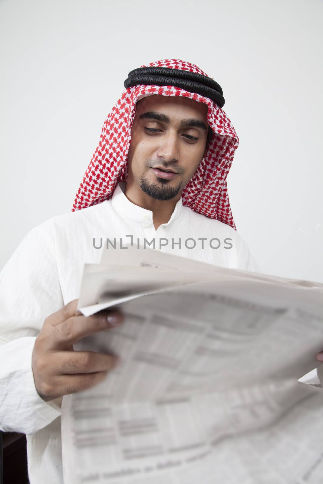 Arab man reading investment profit by haiderazim