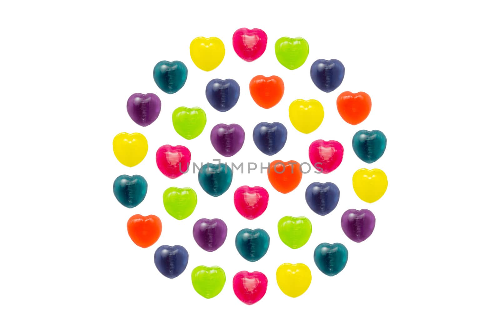 Heart shape confectionery is set in full circle style on white background