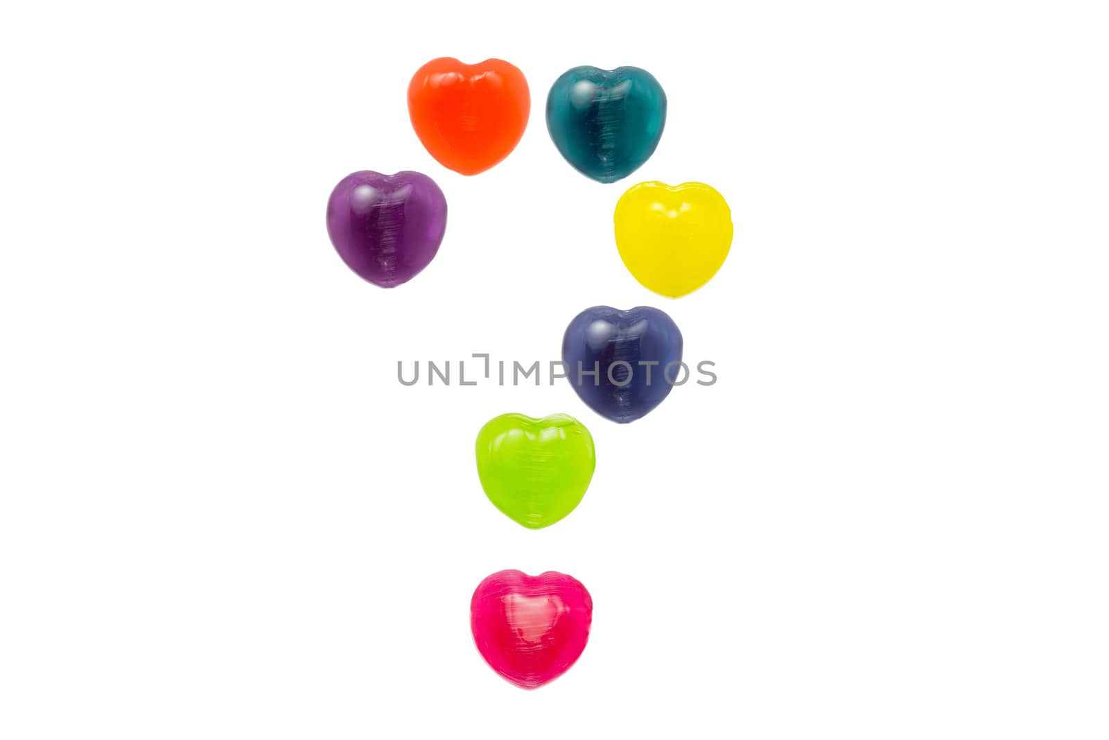 Heart shape confectionery is set in question mark style on white background