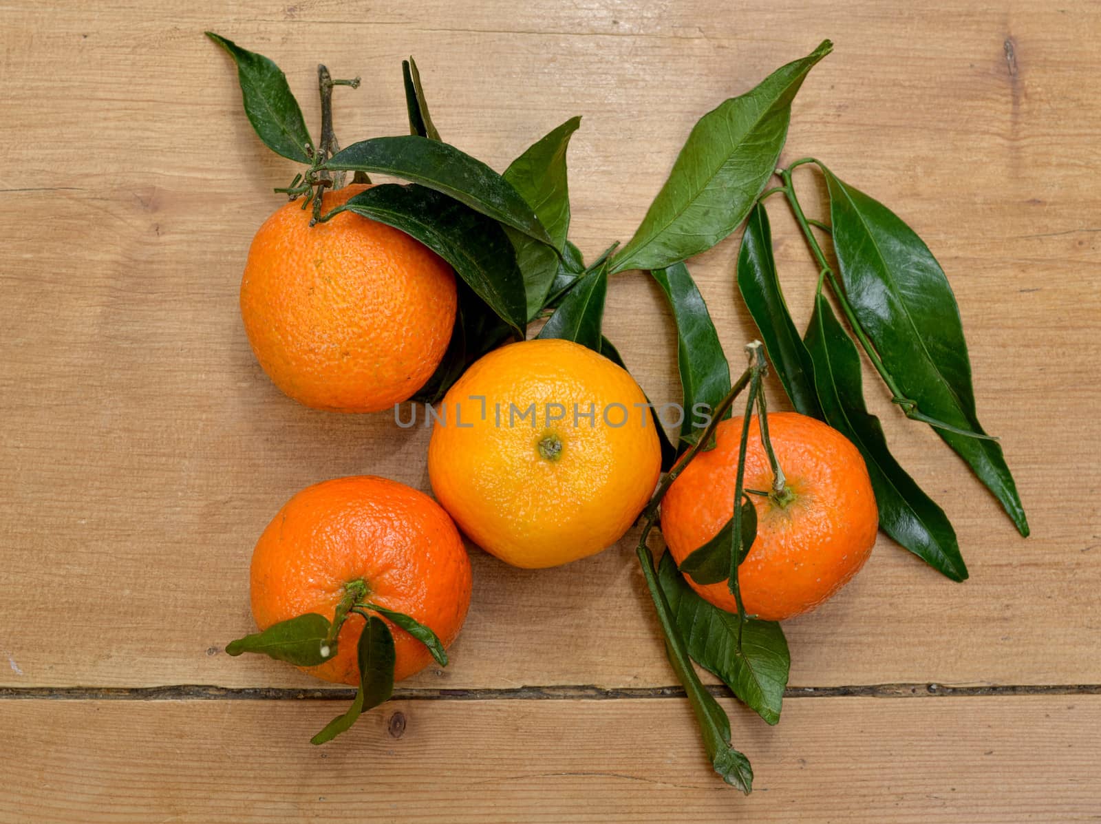 several mandarins placed on a wooden table 